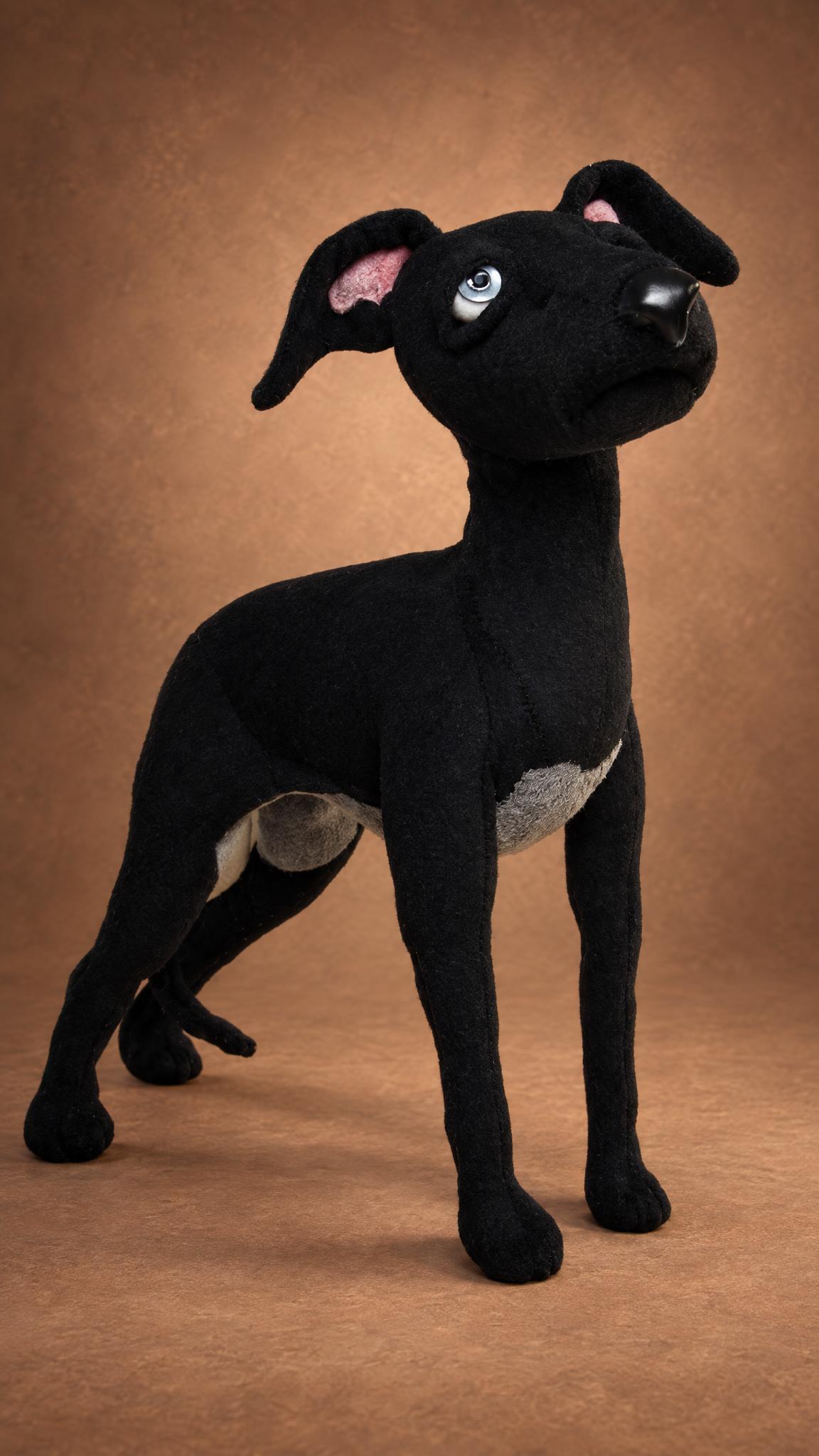 Handmade whippet plush toy standing on thin legs, black plush and pale blue glass eyes, sewn to order