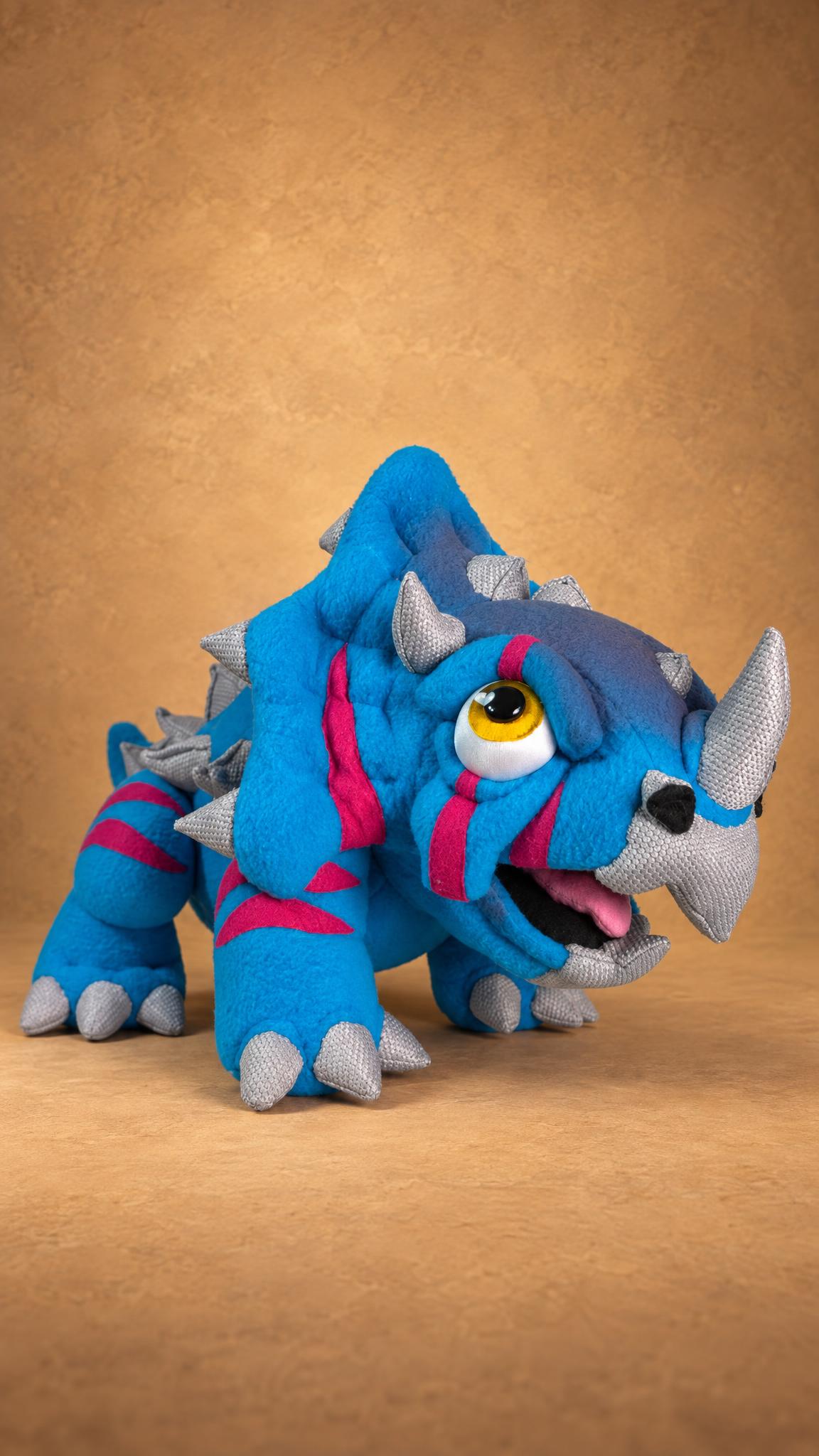 Handmade triceratops creature plush, big yellow eye and grey horns, a custom plush from a drawing