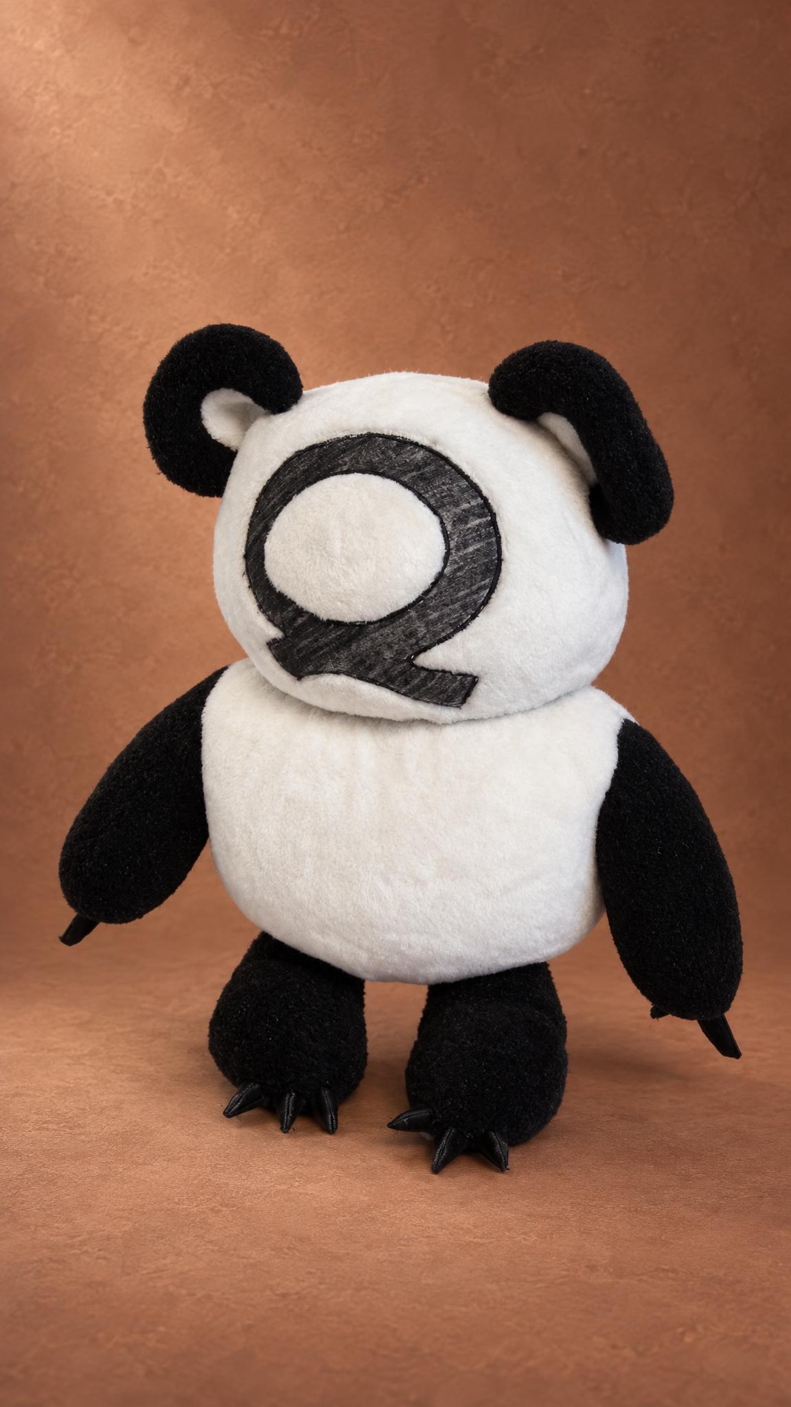 Custom plush from a sketch: a black and white bear with claws and a big letter Q on its face, handmade to order