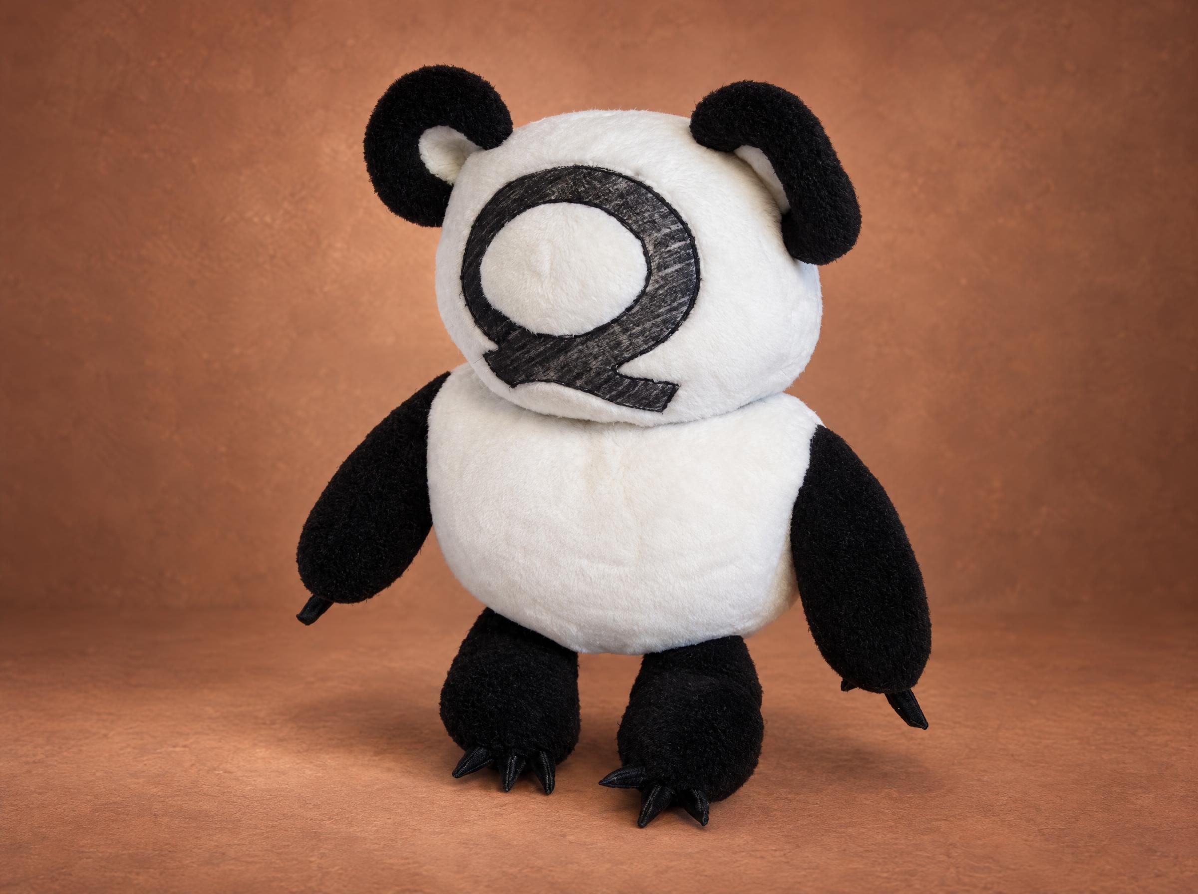 Winnie-the-Q, a bear plush sewn to order from a pencil sketch: white body, black ears and paws, a big Q for a face