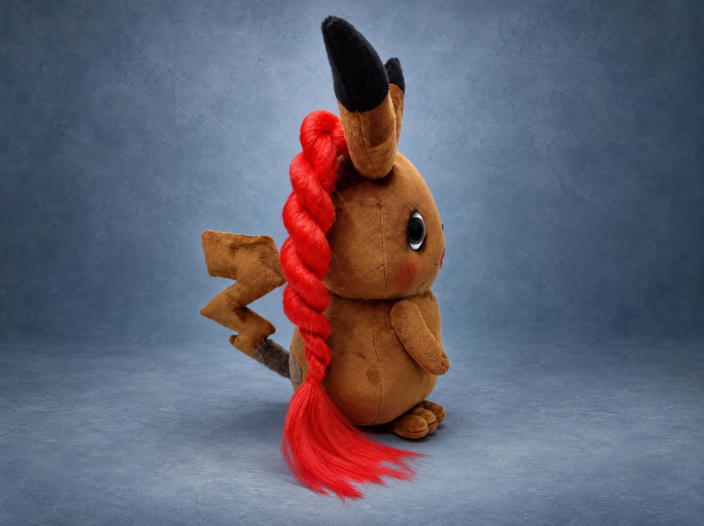 Zoe Wees Pikachu plush, red braid and tail Zoe Wees Pikachu plush from the side: one long red braid down the back, black-tipped ear and the lightning tail, sewn to order
