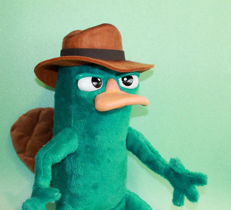 Agent P plush with sly eyes Agent P plush with sly half-closed eyes, a wide orange bill and a faux suede fedora, made to order