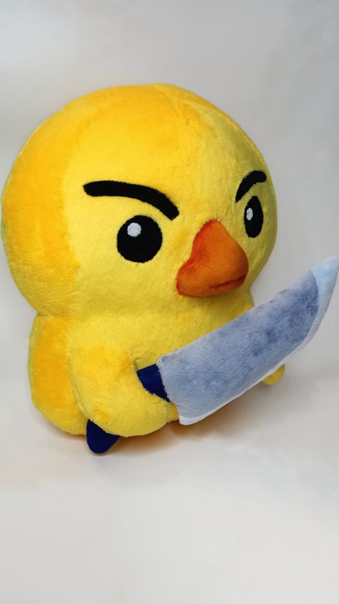 Angry duck with knife plush in yellow with a soft fabric knife, handmade to order from a sticker