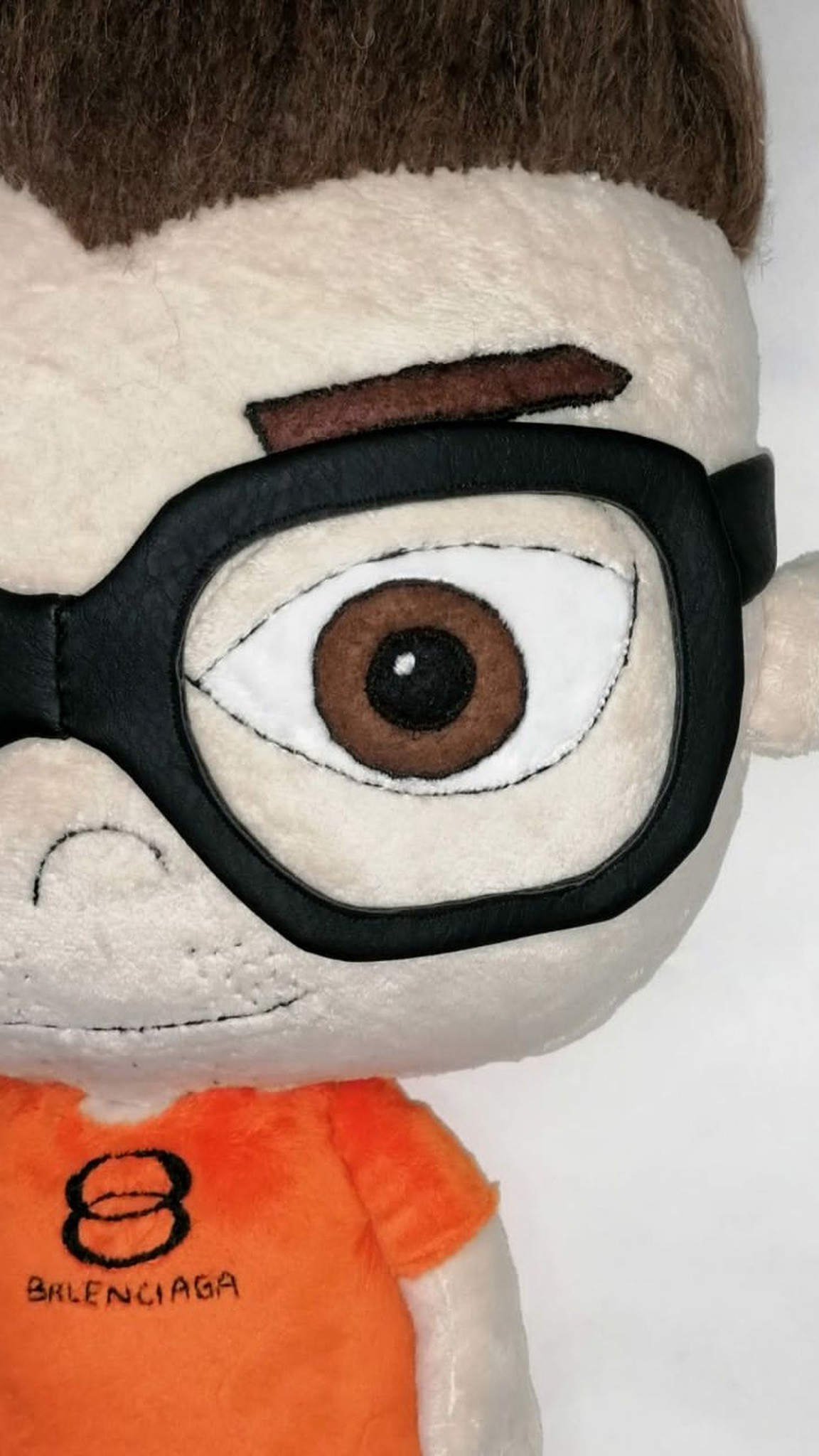 Anime portrait doll with hand-stitched faux leather glasses and a brown felt eye, made to order