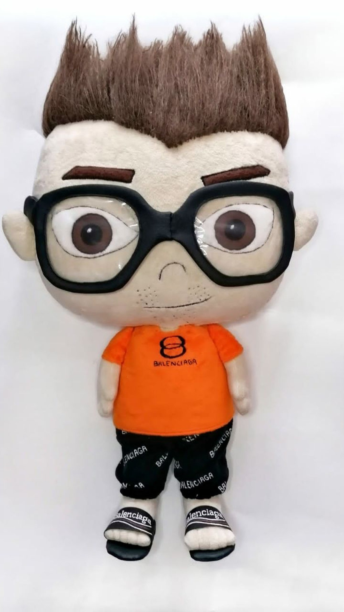 Anime-style doll with spiky brown faux fur hair, felt brows and black square glasses, handmade to order