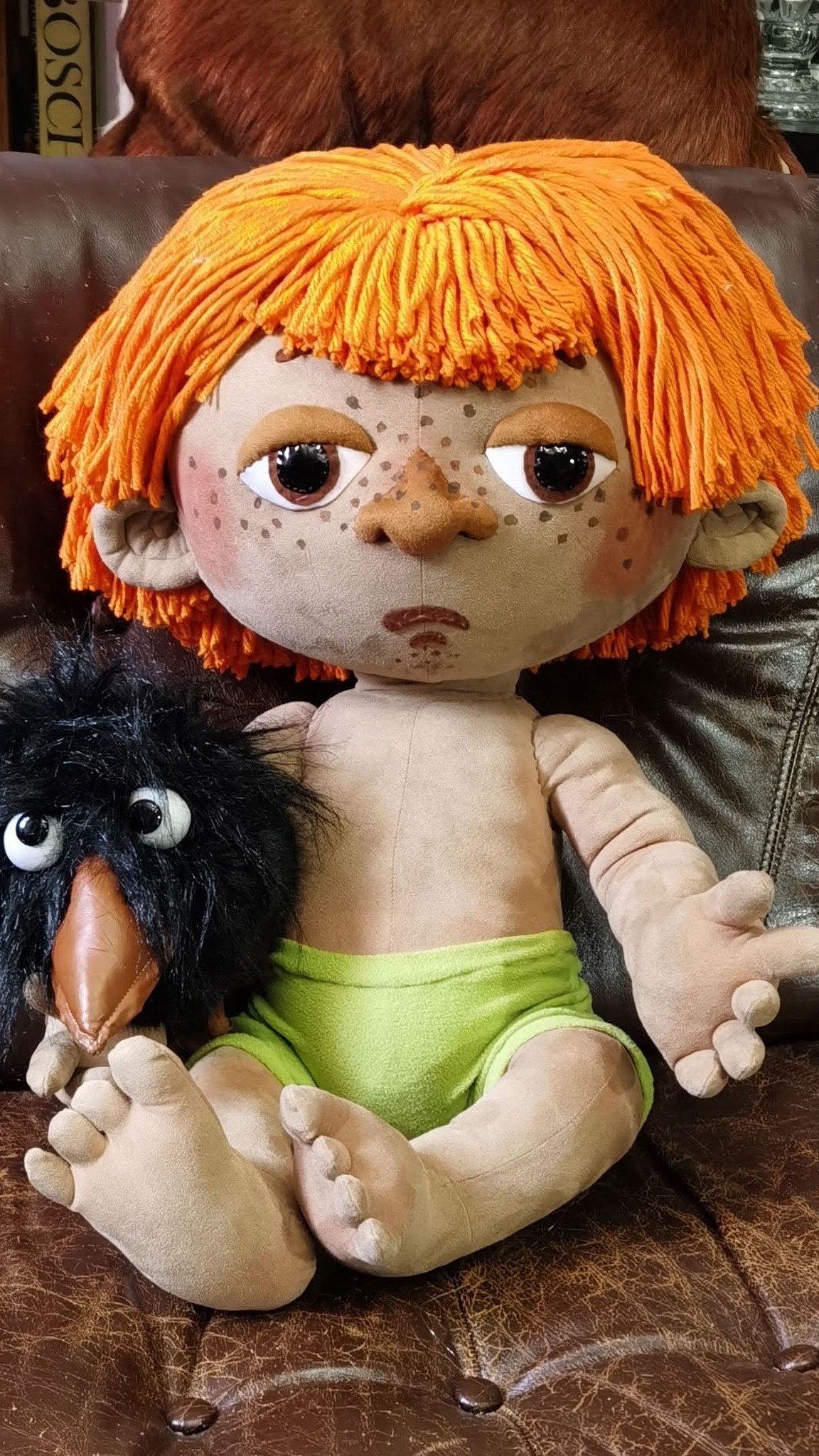 Antoshka doll with an orange yarn fringe, freckles and lime shorts, his crow beside him, made to order