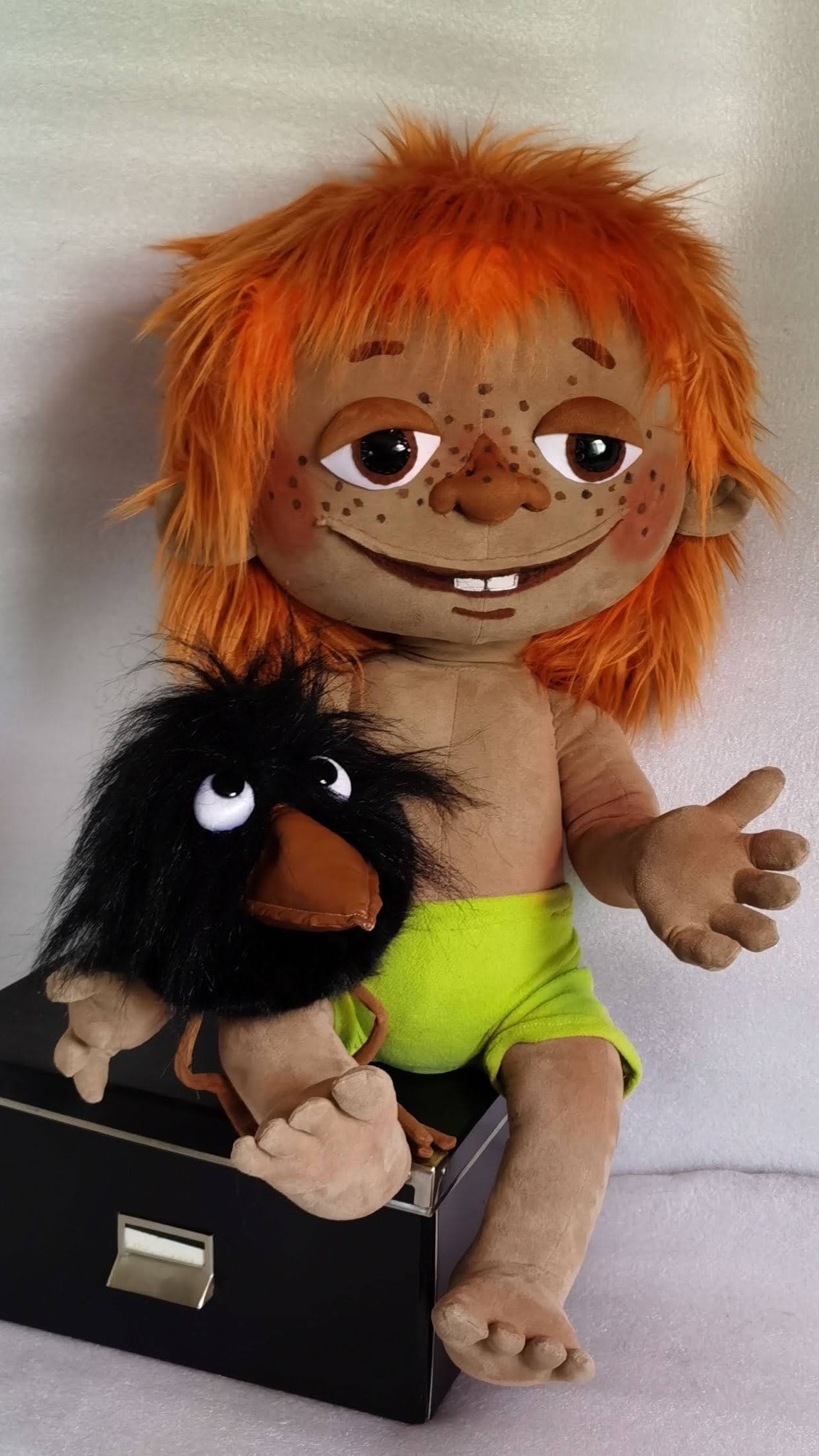 Handmade Antoshka doll with orange faux fur hair and freckles, sitting with his black crow, made to order