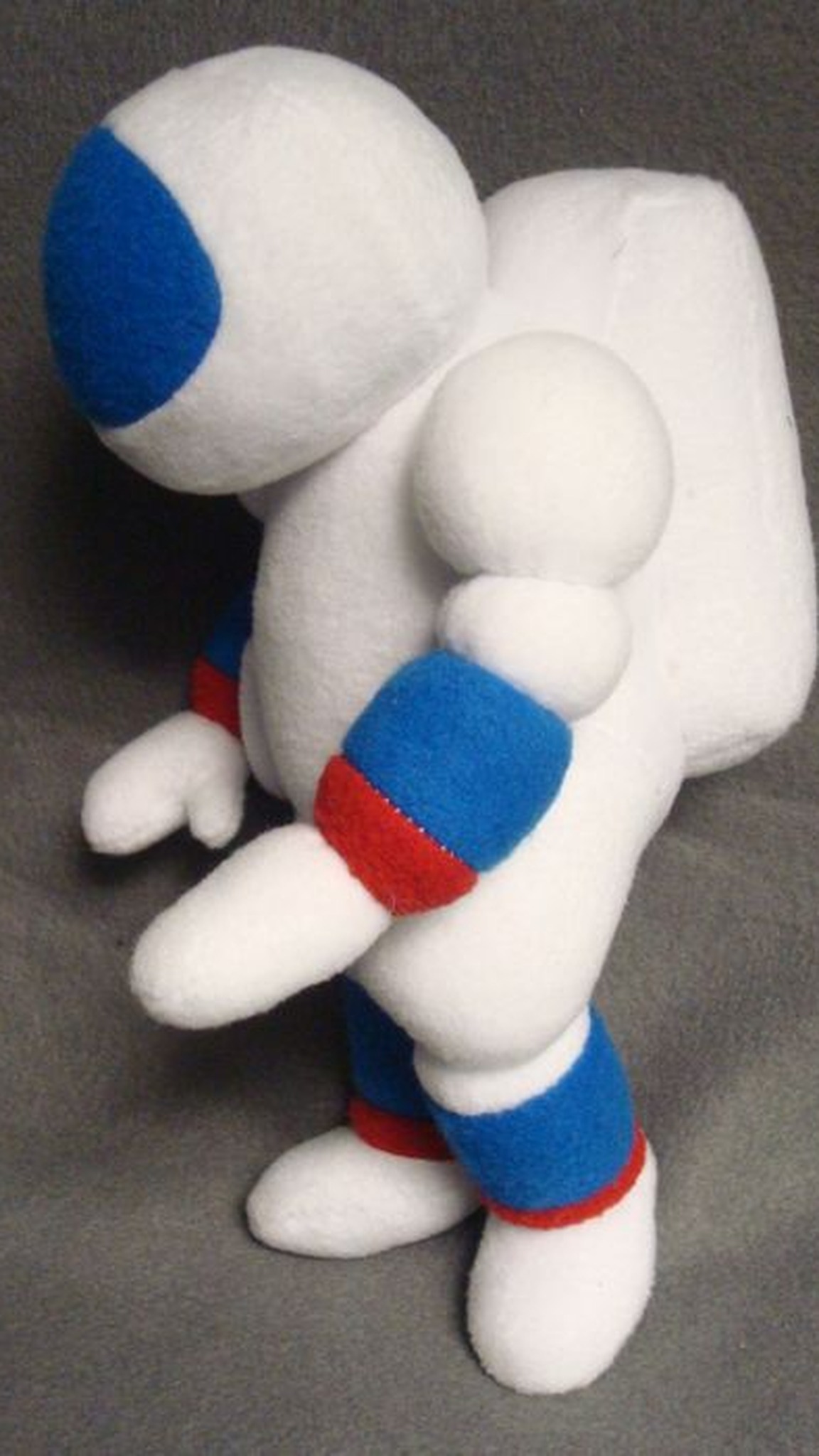 Handmade astronaut plush with a soft white backpack, the cosmonaut we sewed to order that flew to the ISS