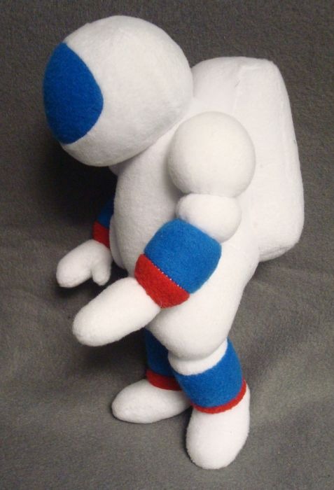 Astronaut plush with a backpack Astronaut plush with a boxy fleece backpack and red-striped blue cuffs, sewn to order for TV