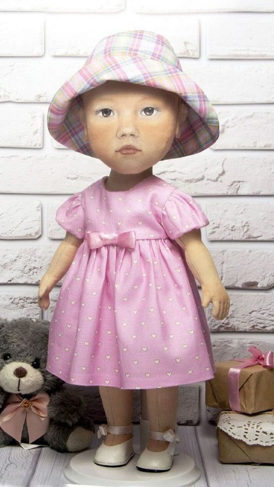 Baby portrait doll in a pink dress, plaid bucket hat and white ribbon shoes, handmade to order from a photo