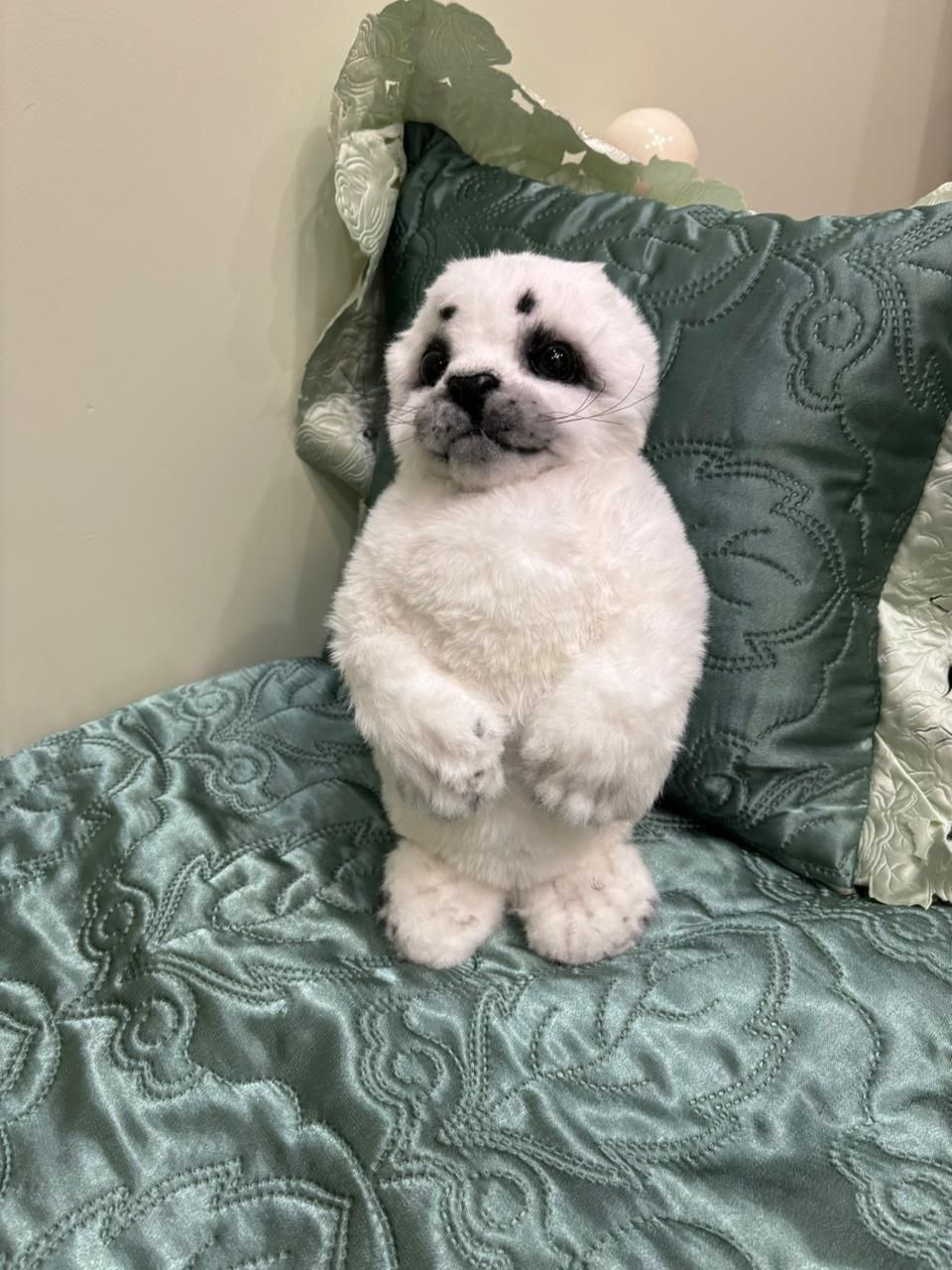 Baby seal stuffed animal standing Baby seal stuffed animal standing up against a pillow, white faux fur and folded flippers, sewn to order