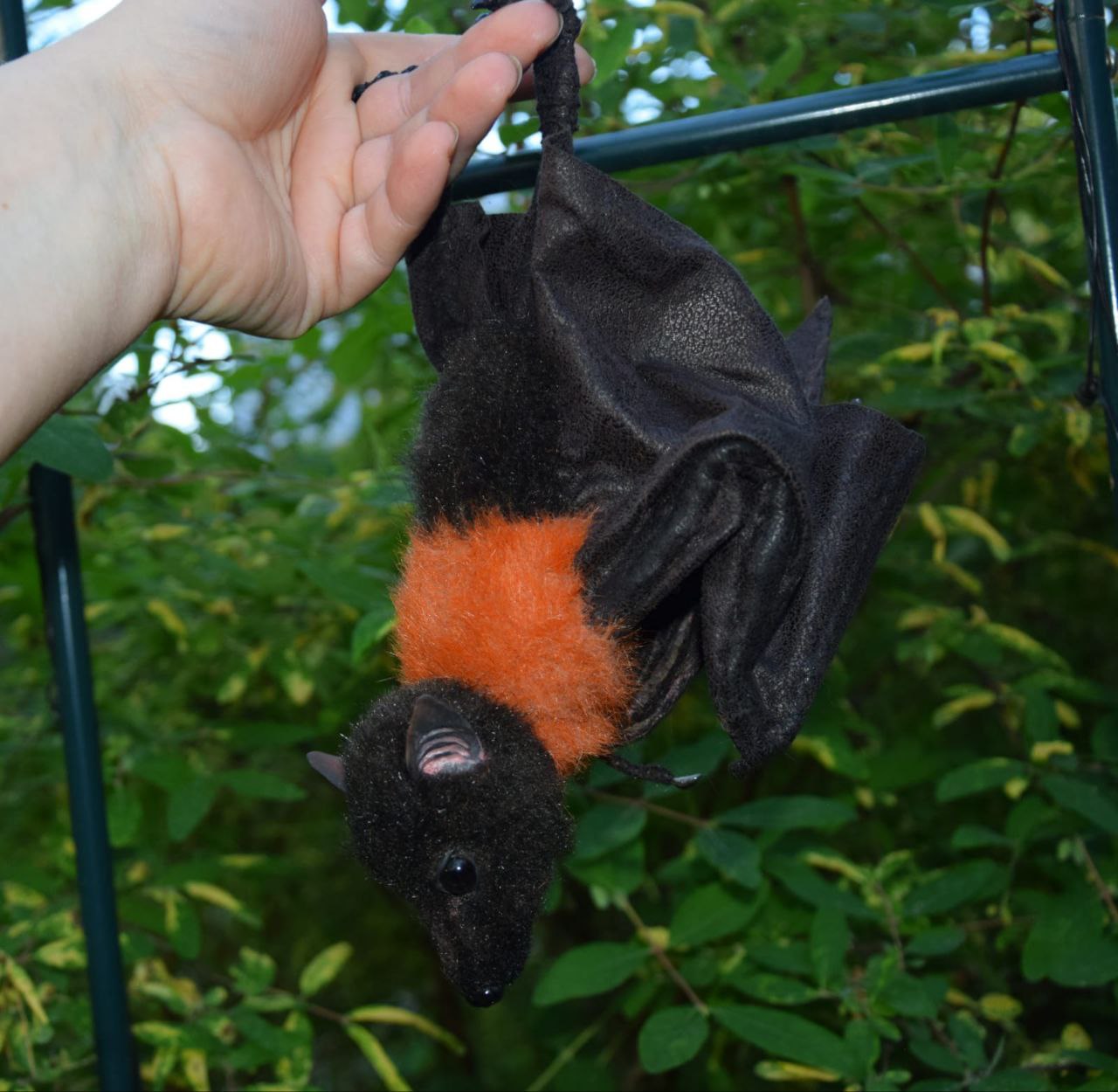 Bat stuffed animal with orange collar Bat stuffed animal upside down, showing her orange faux fur collar and pink inner ears, a custom bat plush