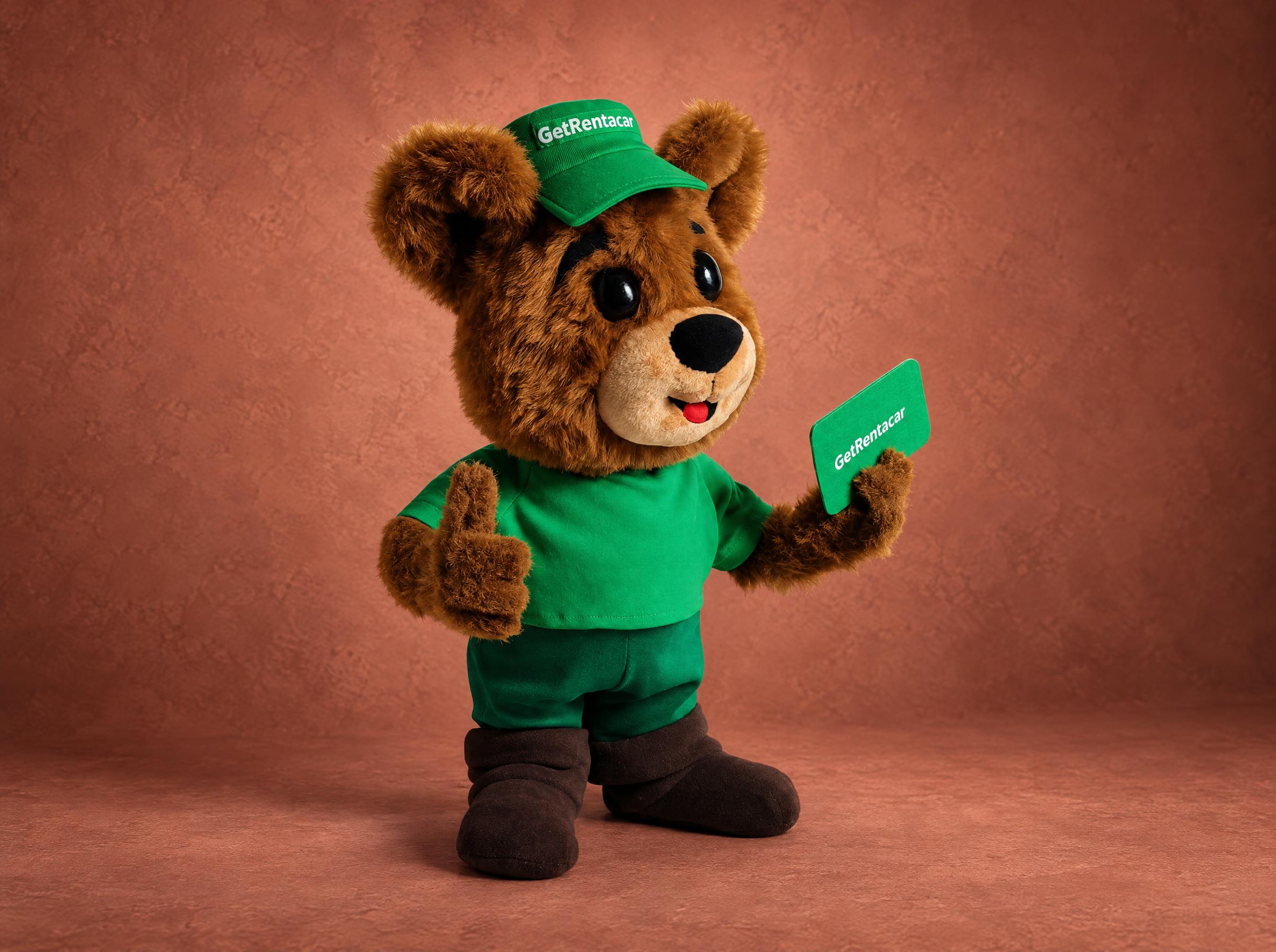 Bear mascot plush from a company logo: brown faux fur bear in green cap and T-shirt, thumbs-up, made to order