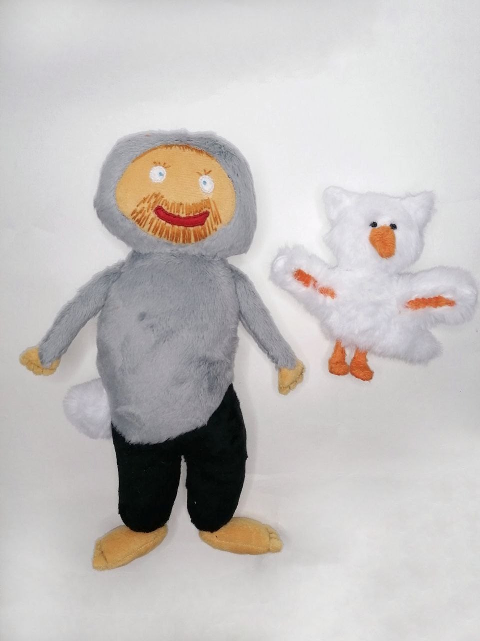 Bearded man doll and white bird plush Bearded man doll in a grey hooded suit with a pompom tail and a white bird plush, sewn from a child's drawing