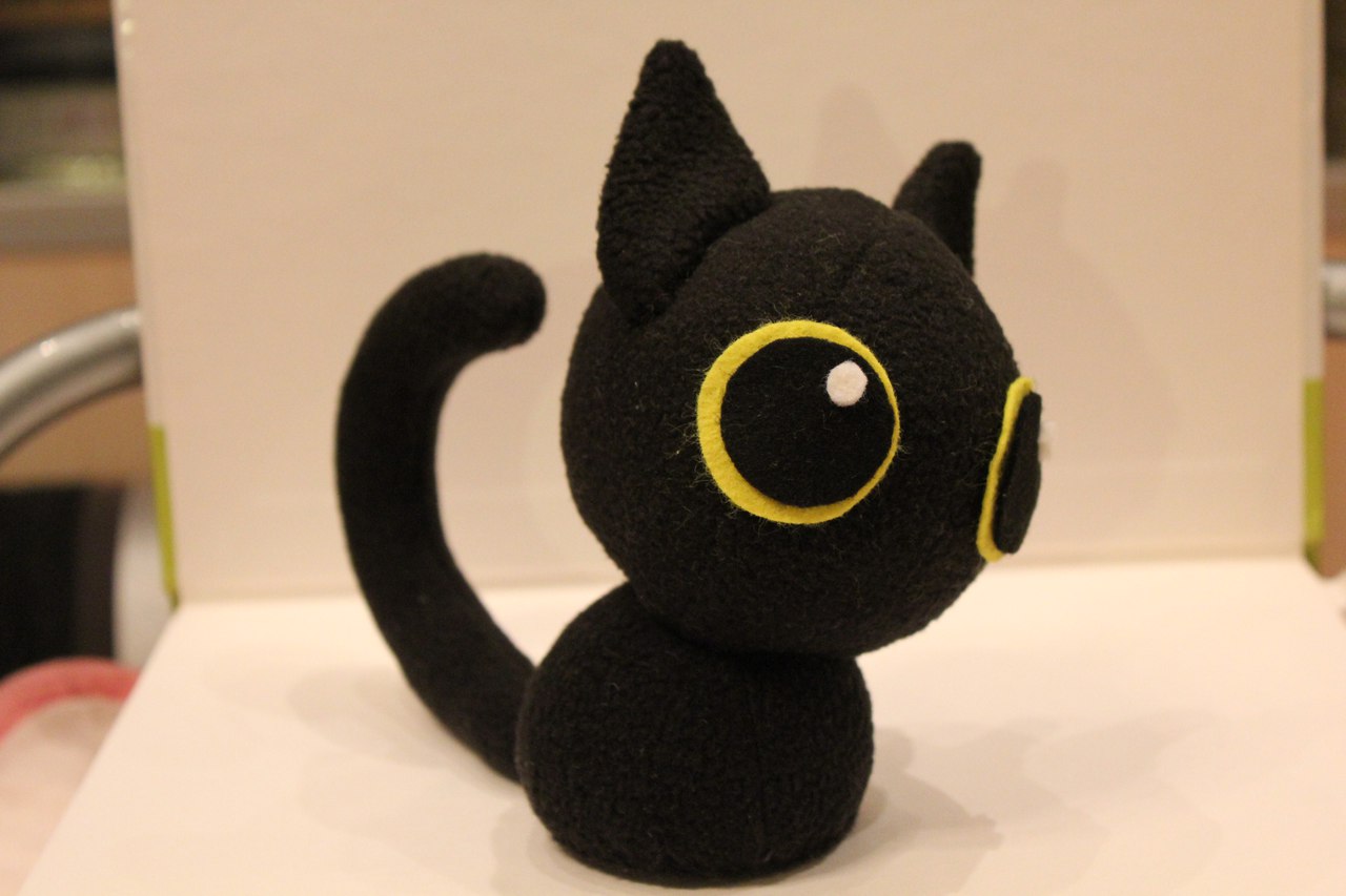 Big-eyed black cat plush with yellow eyes Big-eyed black cat plush with yellow felt eye rings and a white highlight dot, made to order by hand