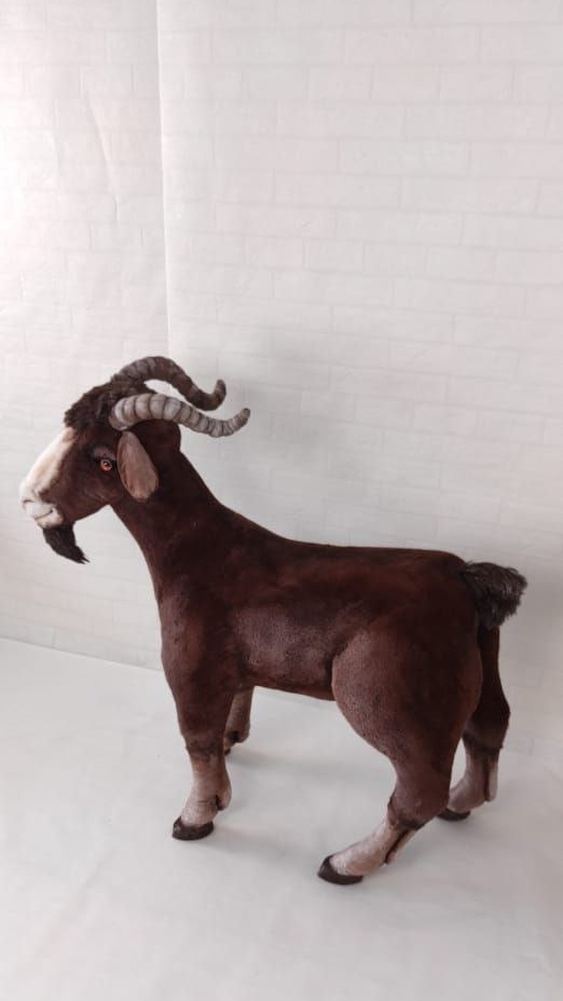 Big goat stuffed animal with a dark beard, curled horns and a short tail, sewn by hand to order