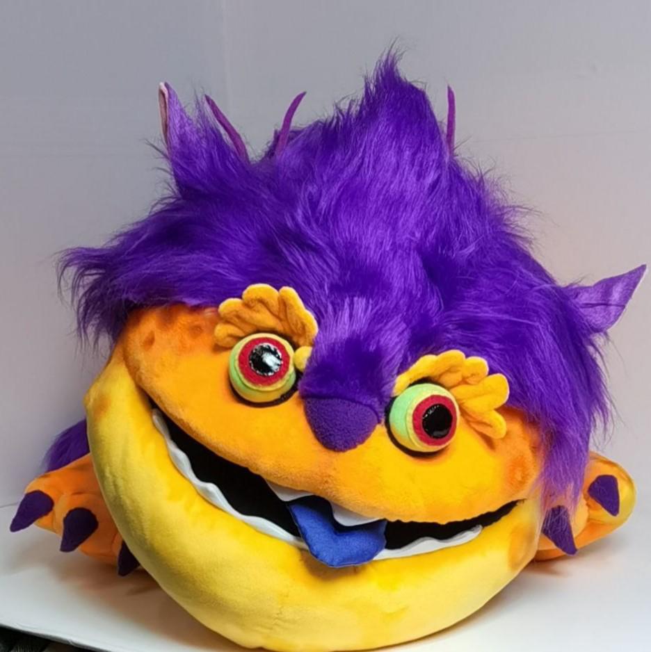 Big Orange plush face Big Orange plush face: green eyes with red rims, ruffled yellow brows and a purple nose, custom Martian toy