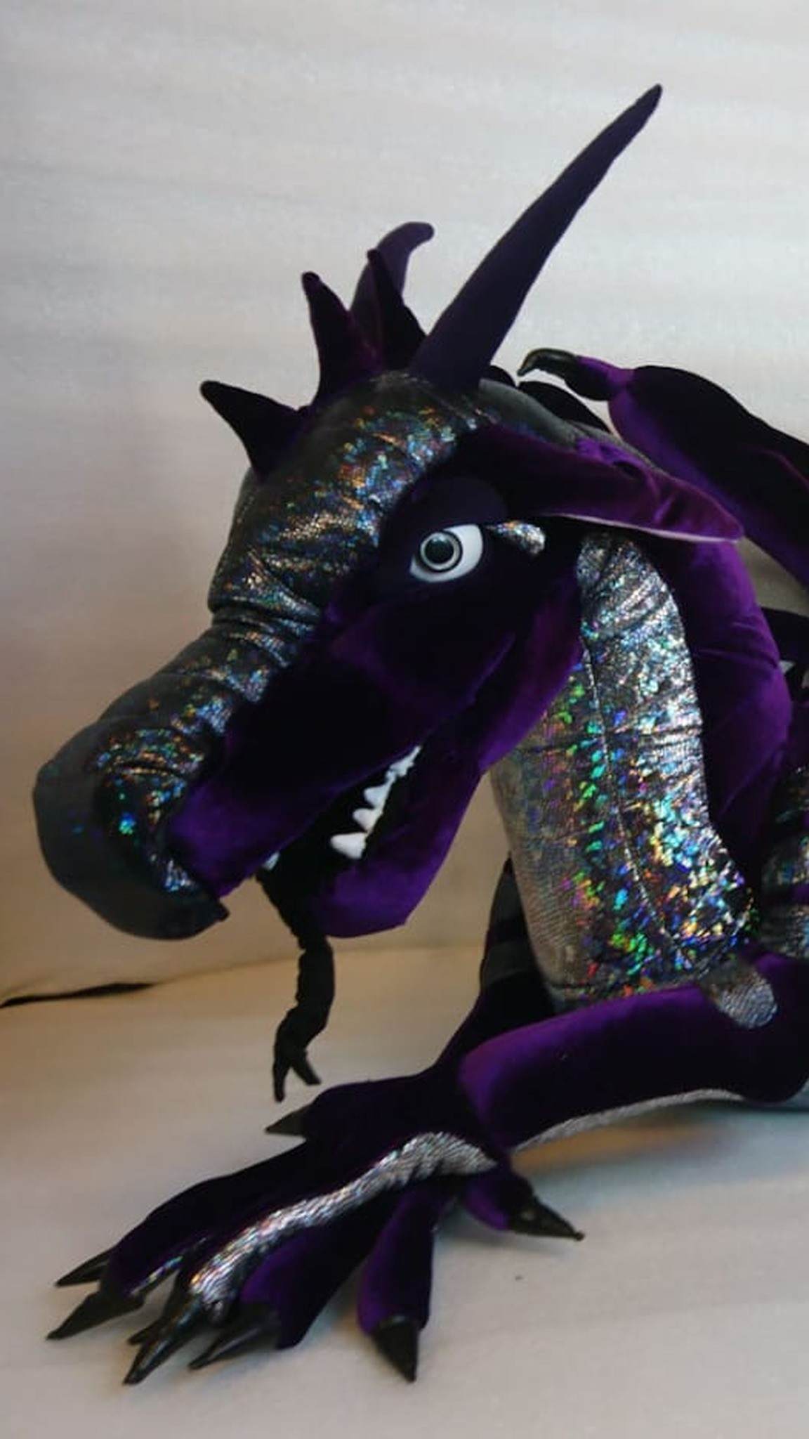 Black and purple dragon plush with tall horns and braided whiskers, made to order from a drawing