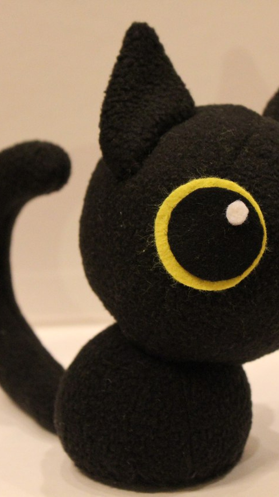 Black kitten stuffed animal with big yellow-rimmed eyes, sewn to order from a customer's drawing