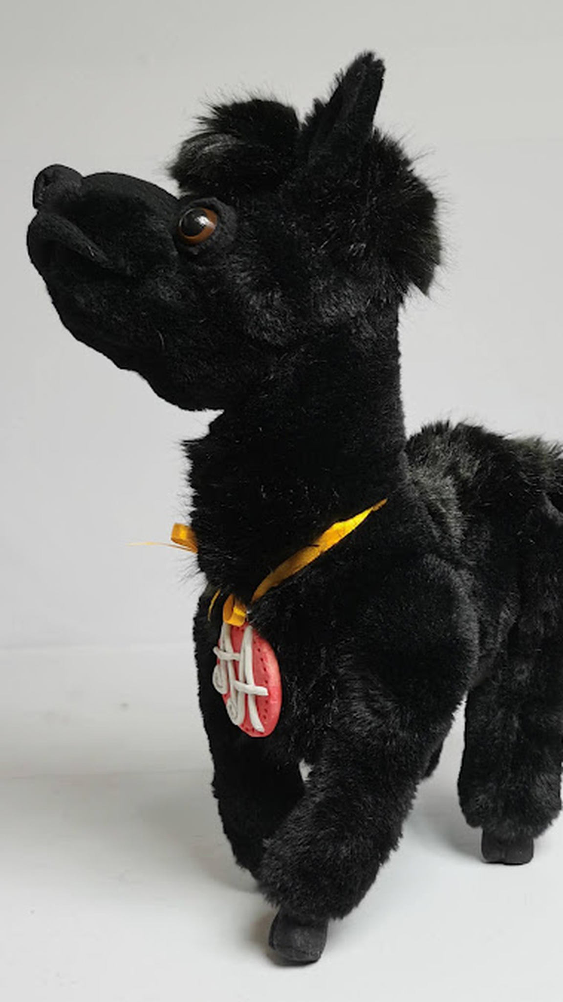 Soft llama toy from a photo: dark faux fur, thin legs, brown eyes and a monogram tag, made to order