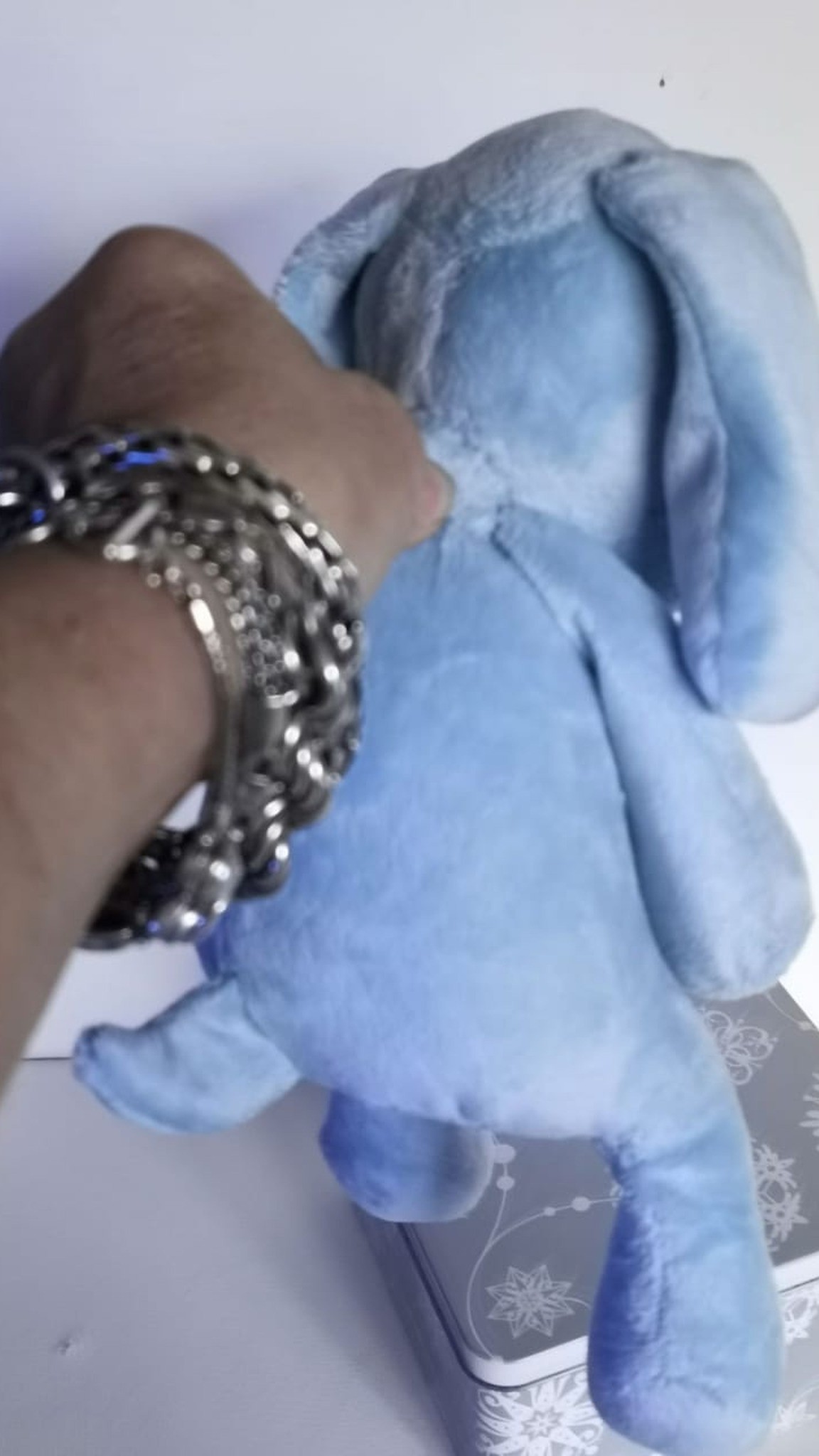 Blue dog plush in soft faux fur held up by hand, short upright tail, made to order from a photo