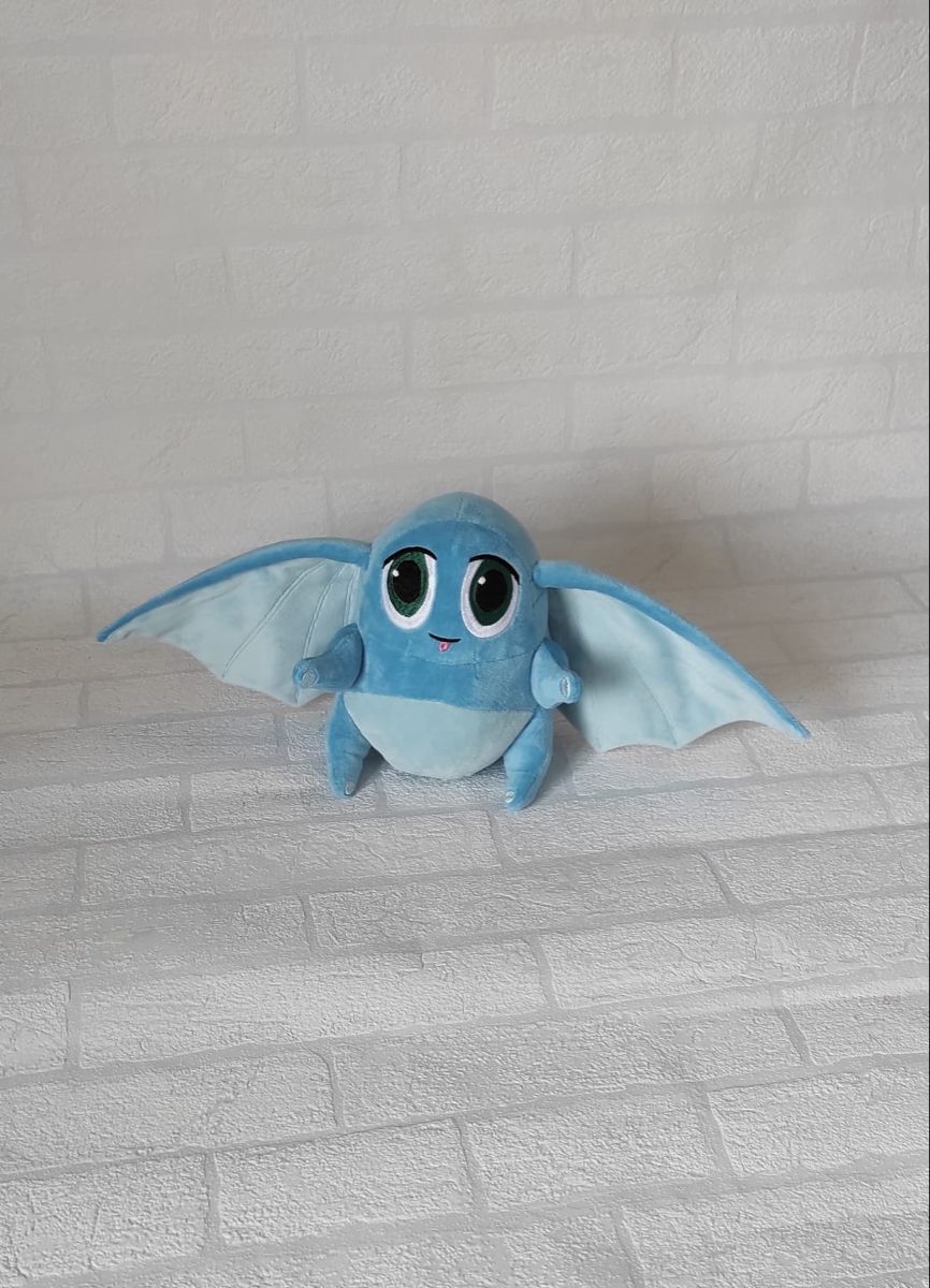 Eared character plush by the brick wall Eared character plush by a white brick wall, ribbed pale blue ears spread wide, handmade to order from sketches