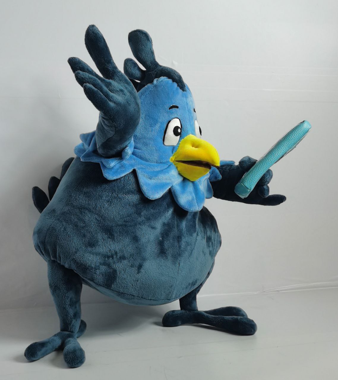Blue phoenix plush waving a wing Blue phoenix plush waving a feathered wing, embroidered eyes and yellow beak, custom mascot sewn to order