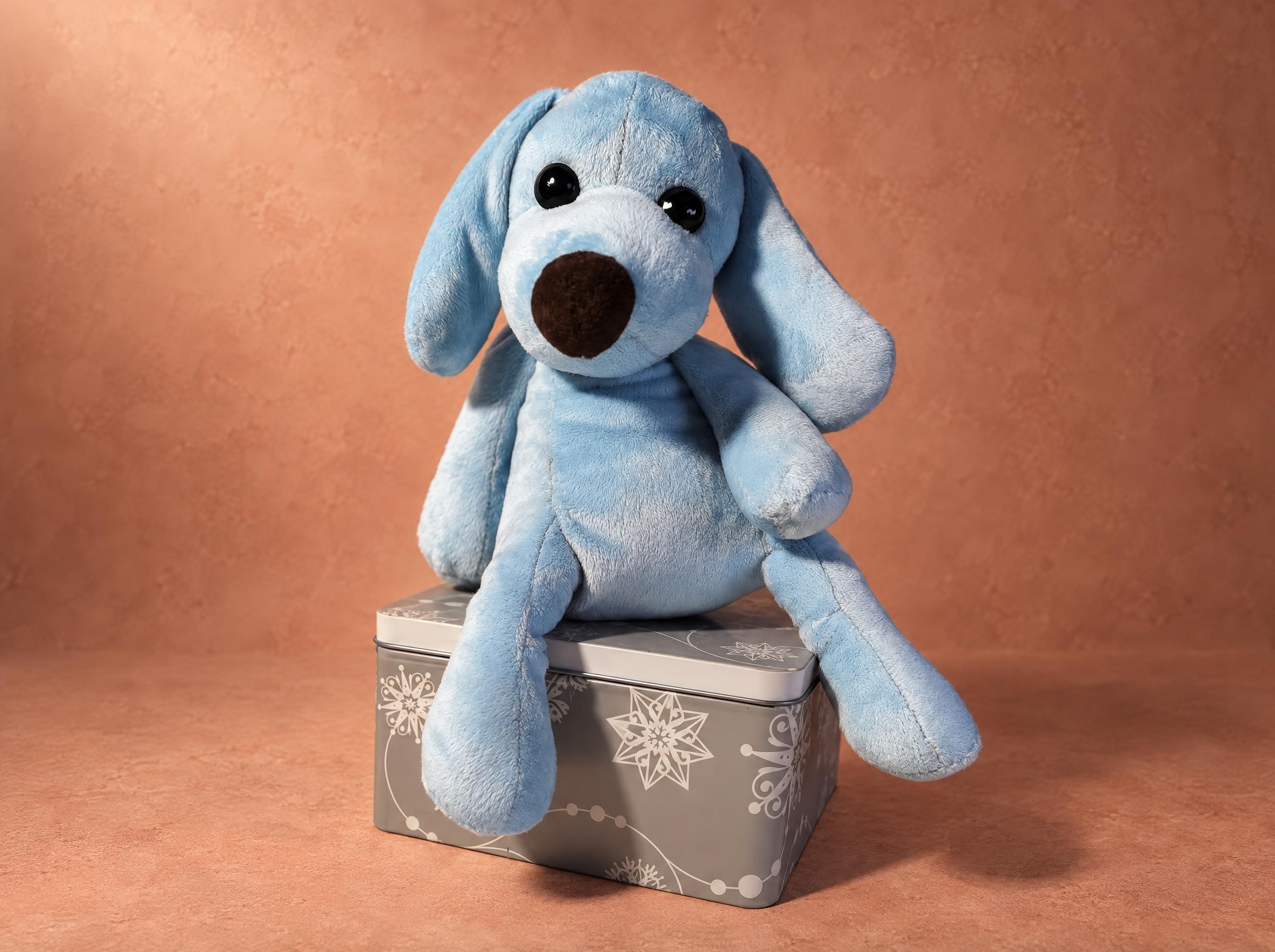 Blue stuffed dog with floppy ears and a brown nose, sewn to order from a photo of the original toy