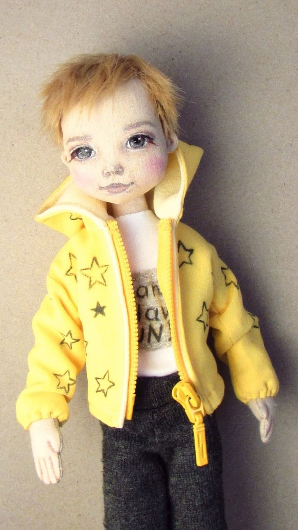 Boy doll that looks like a real child: messy ginger hair, painted blue-grey eyes, yellow zip hoodie, handmade
