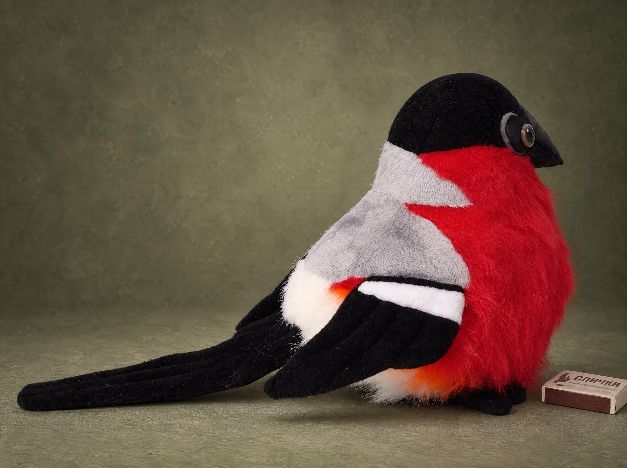 Realistic bullfinch plush with a red faux fur breast, black cap, grey back and long black tail, made to order