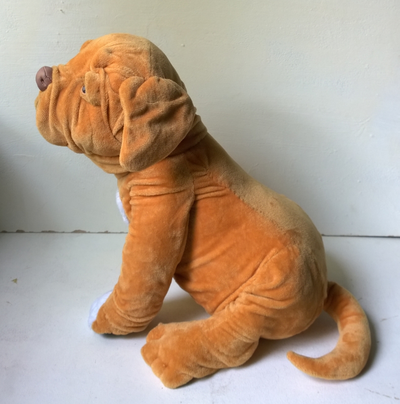 Bullmastiff plush replica with a curled tail Bullmastiff plush replica of a real dog in profile with a wrinkled neck and curled tail, sewn to order