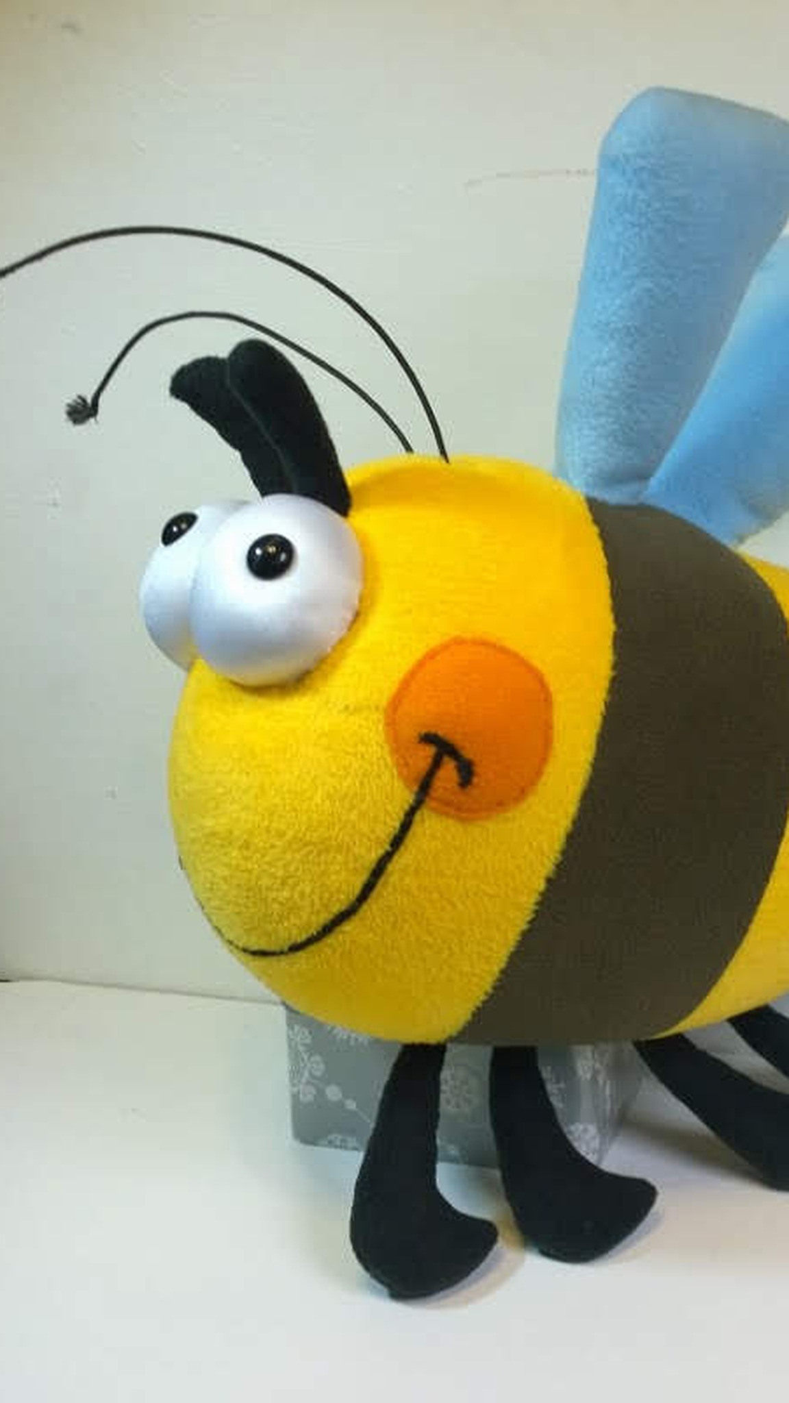 Bumblebee plush with an olive-brown stripe and googly eyes, a later handmade copy of the same custom design