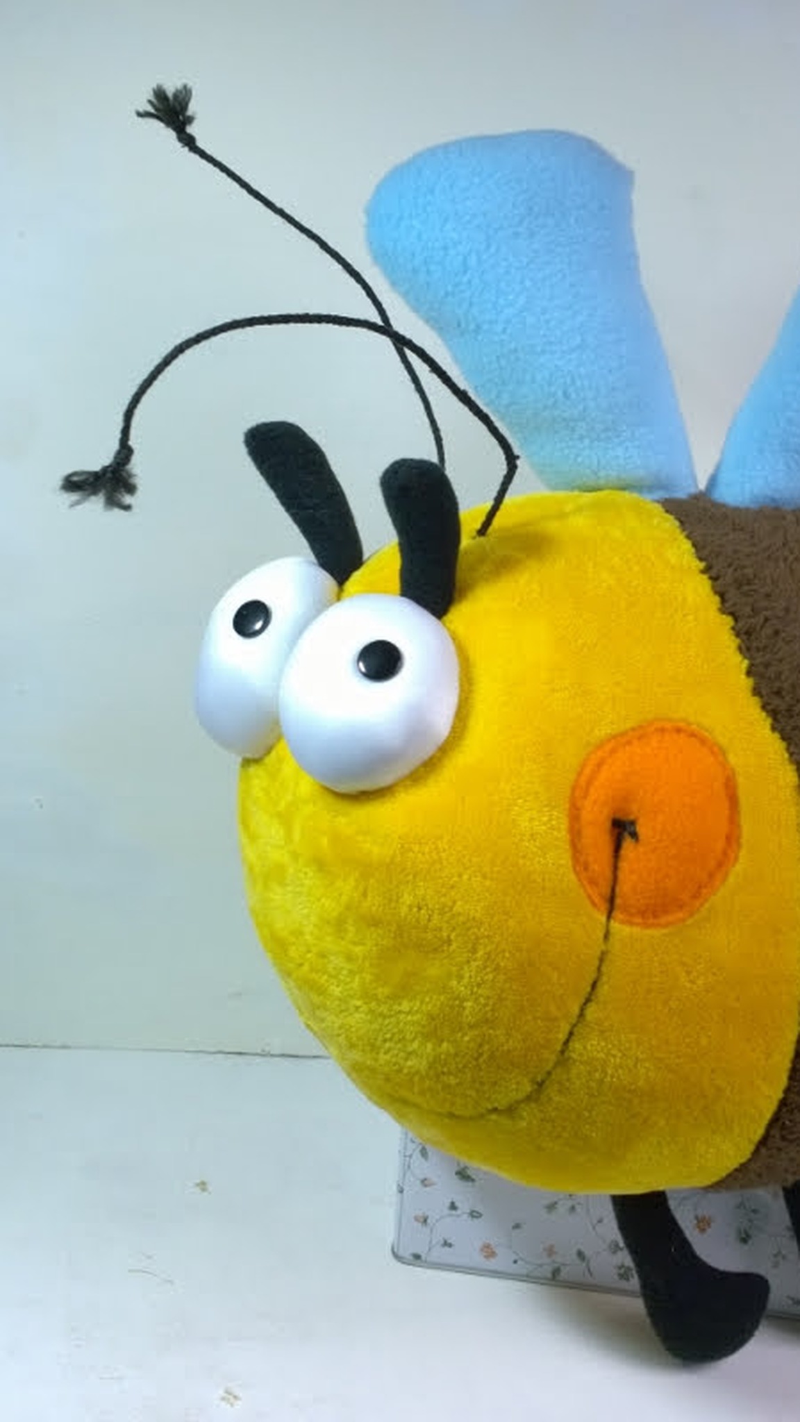Another bumblebee plush pillow of the same design, dark brown stripe and blue wings, sewn to order