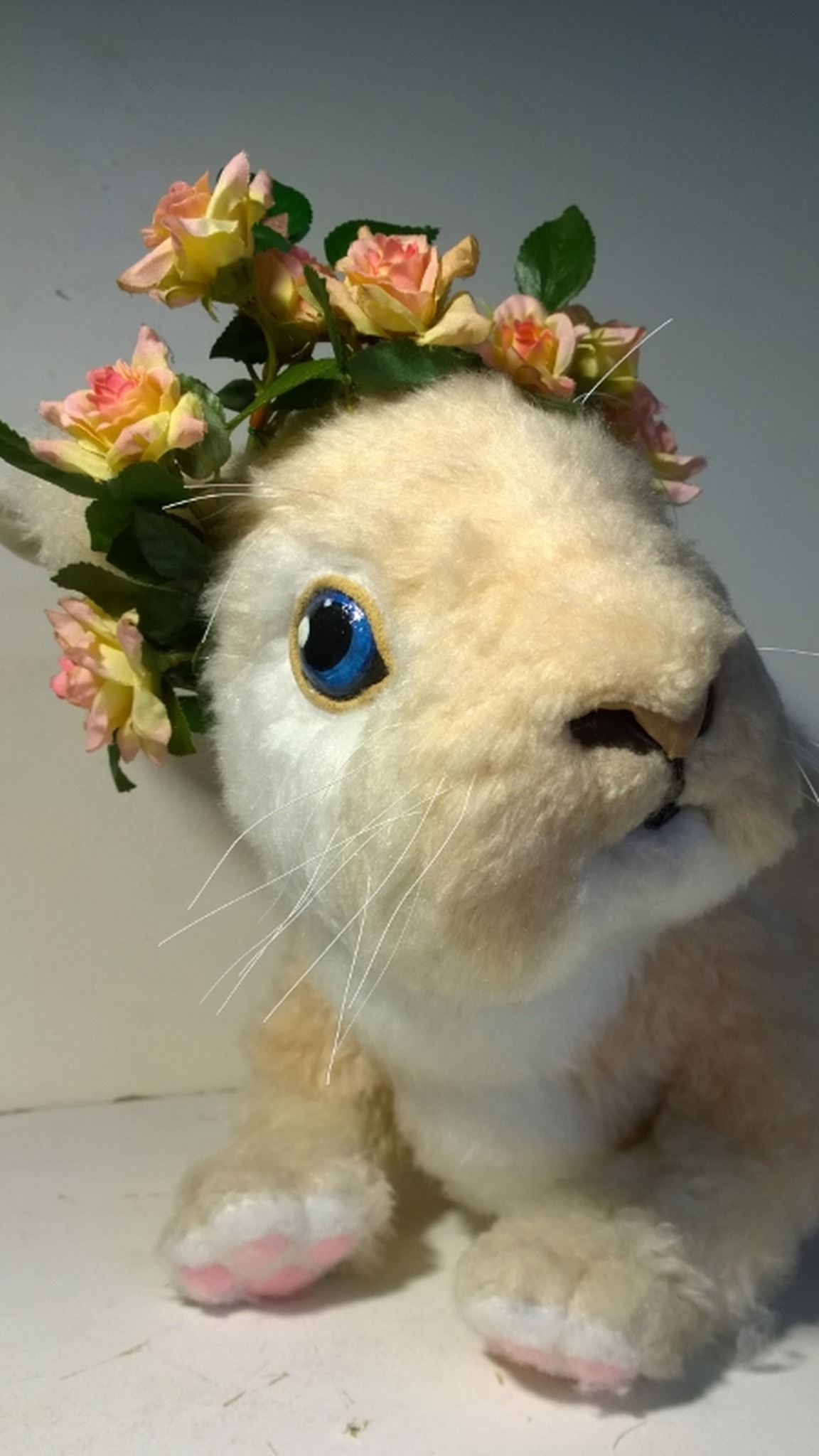 Bunny plush with gold-rimmed blue eyes, white whiskers and a rose wreath, a realistic stuffed bunny to order