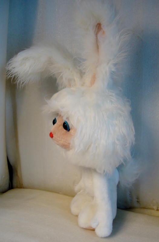 Cartoon bunny plush with a fluffy tail Cartoon bunny plush with long faux fur ears, a big shaggy head and a fluffy white tail, sewn by hand