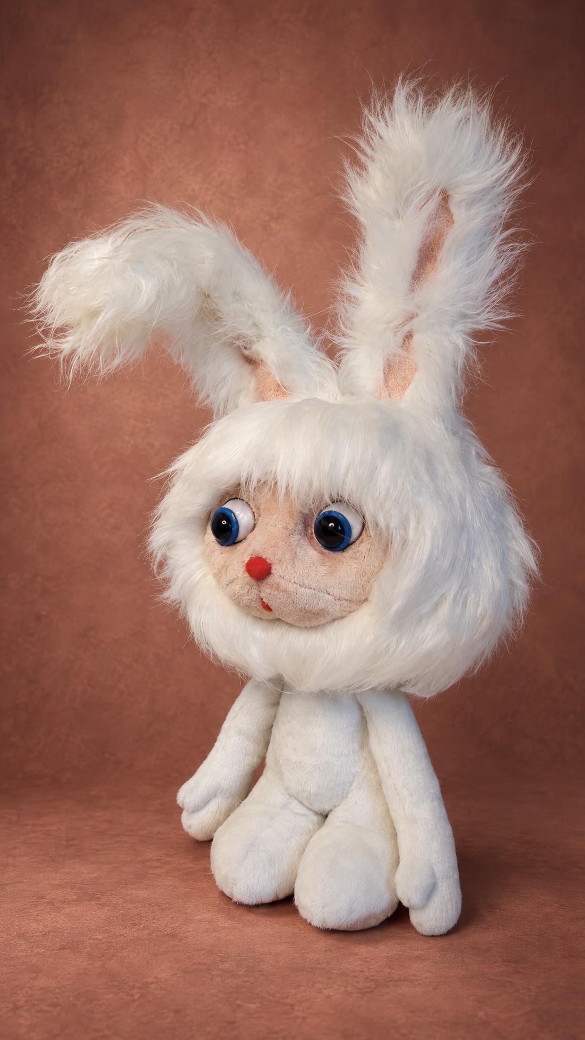 White cartoon bunny plush with one ear up and one flopped over, sewn by hand to order from a cartoon