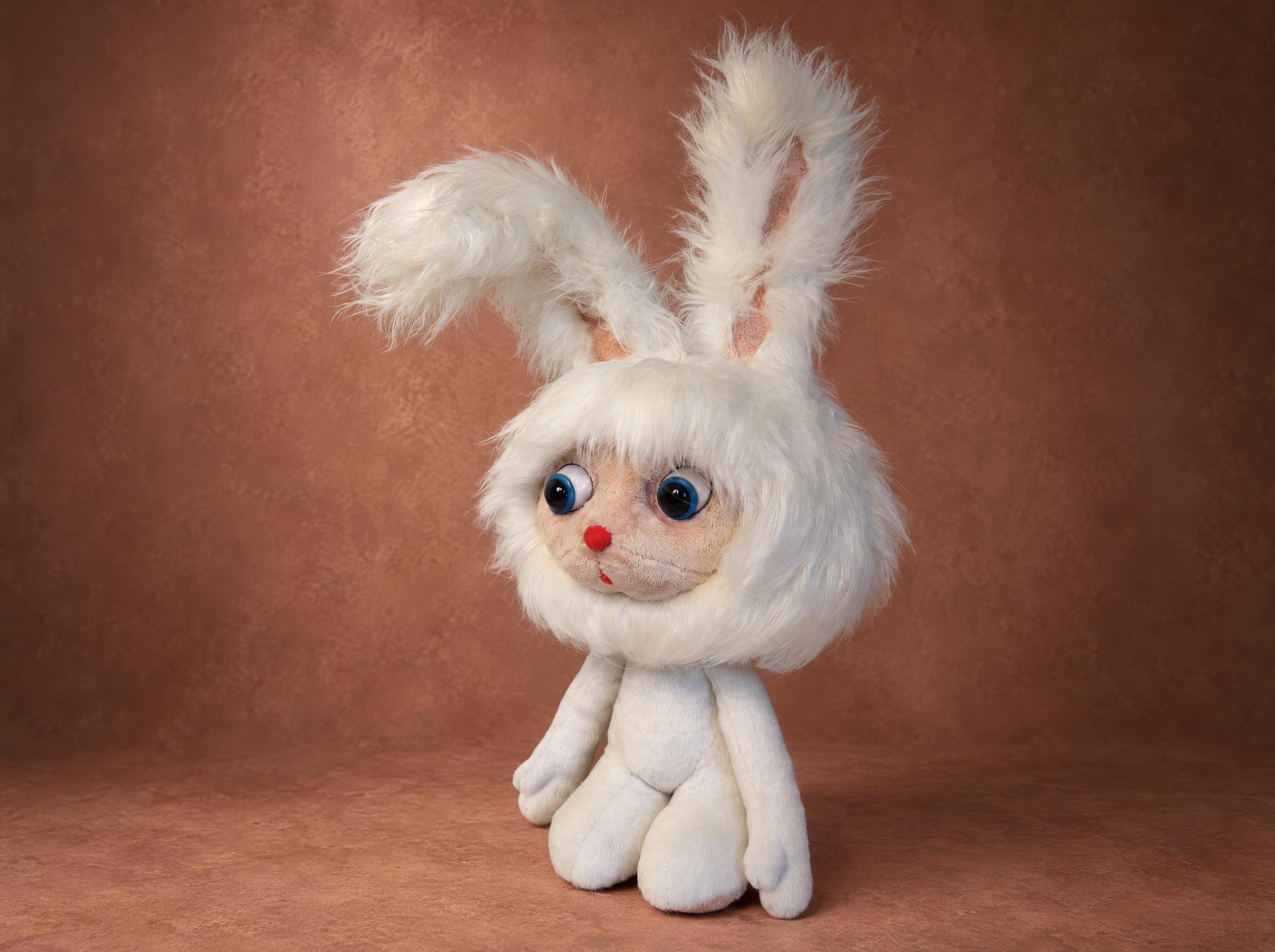 Cartoon bunny plush with a white faux fur hood, big blue eyes and a tiny red nose, handmade to order