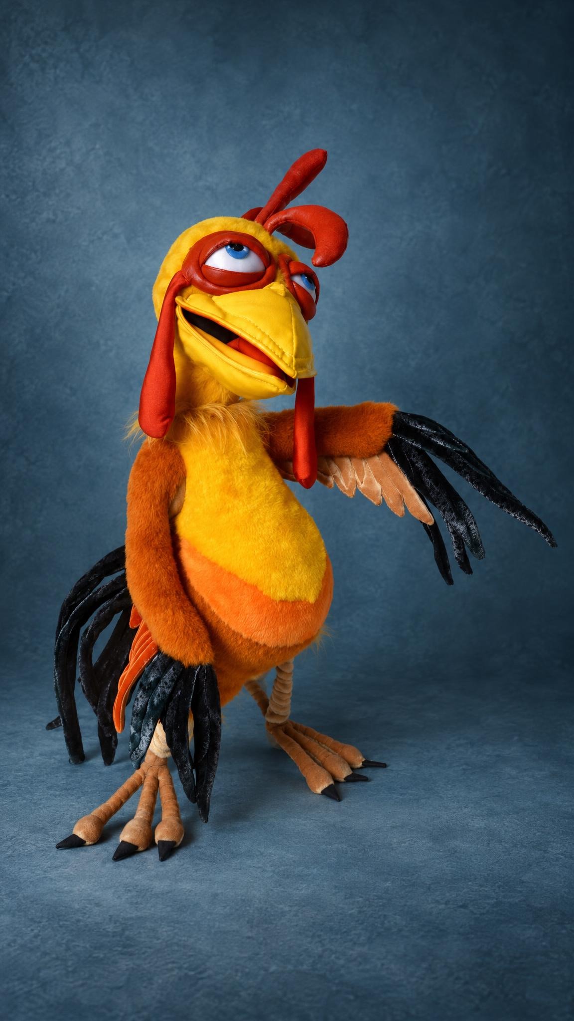 Custom rooster plush on long tan legs, sleepy blue eyes in red rings, yellow and orange body, handmade to order