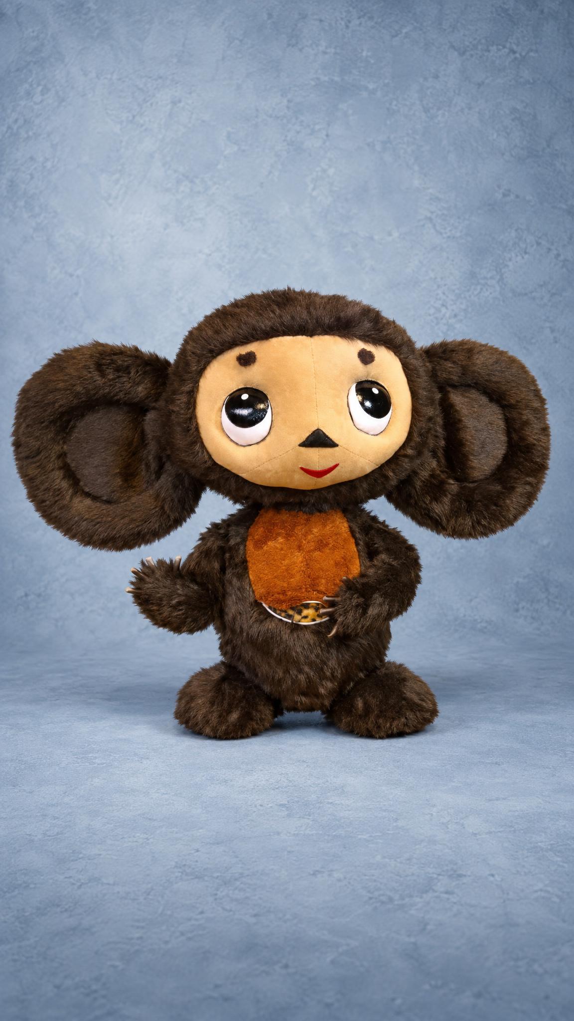 Handmade Cheburashka plush with a beige face, black triangle nose and red smile, sewn to order