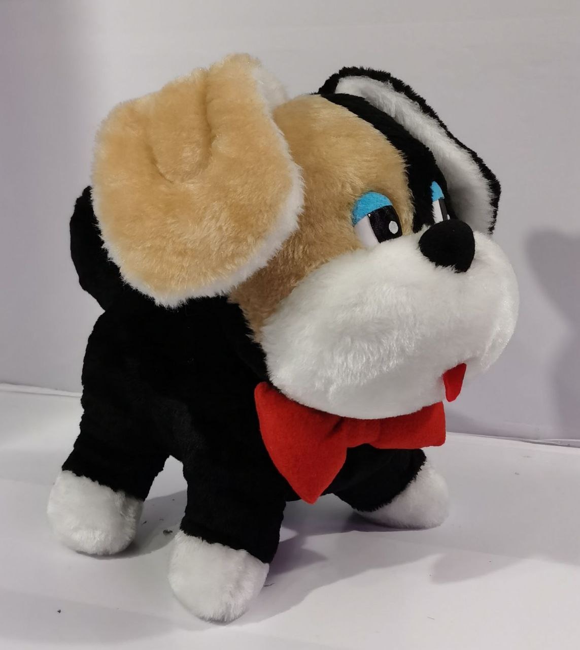 Childhood puppy plush with tan ear and blue eyes Custom childhood puppy plush with a big tan ear, blue eyes and white muzzle, sewn to order from a photo