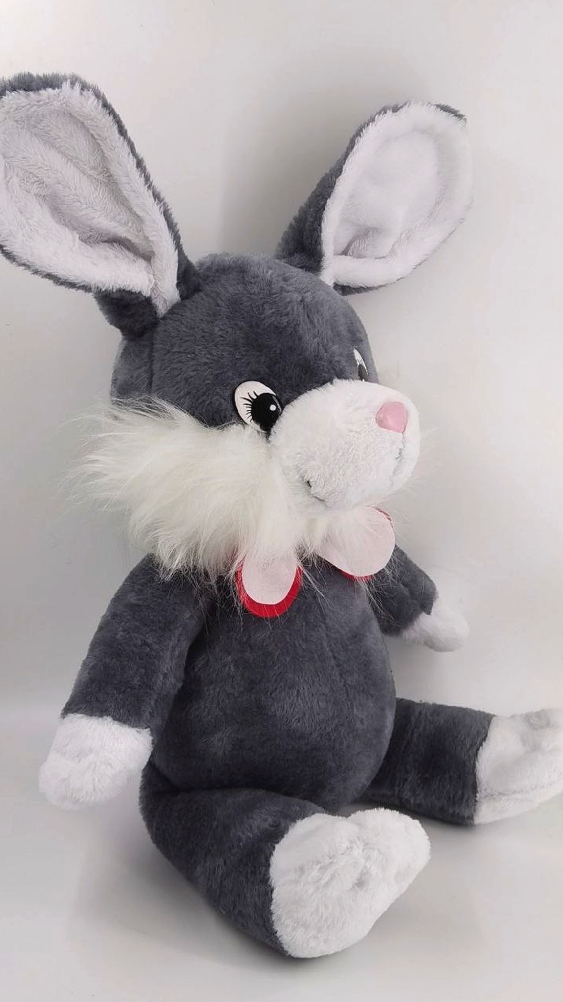 Gray bunny plush replica with white fluffy cheeks and a pink bow, remade by hand from childhood photos