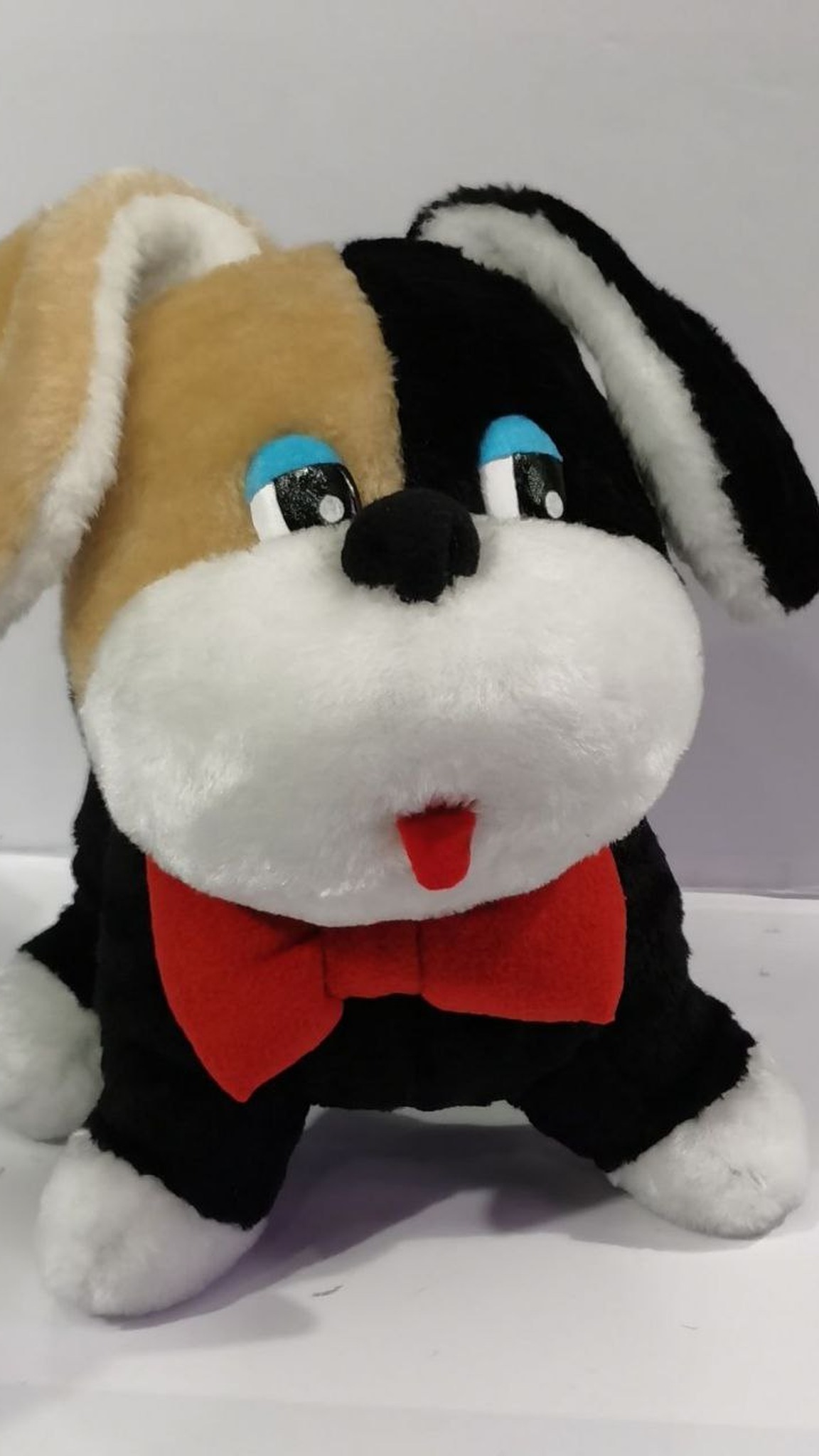 Childhood stuffed dog replica in black faux fur with a red bow tie, recreated to order from a photo