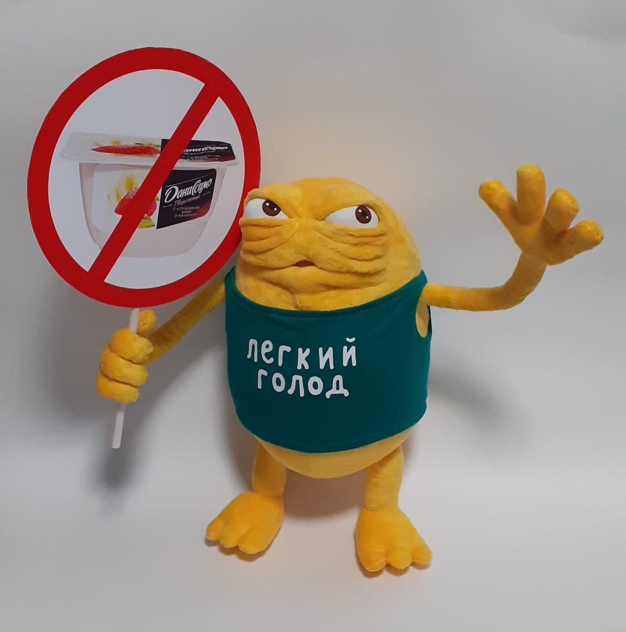Monster mascot plush with a round sign Handmade yellow monster mascot plush from a TV commercial holding a round sign, sewn to order for a brand