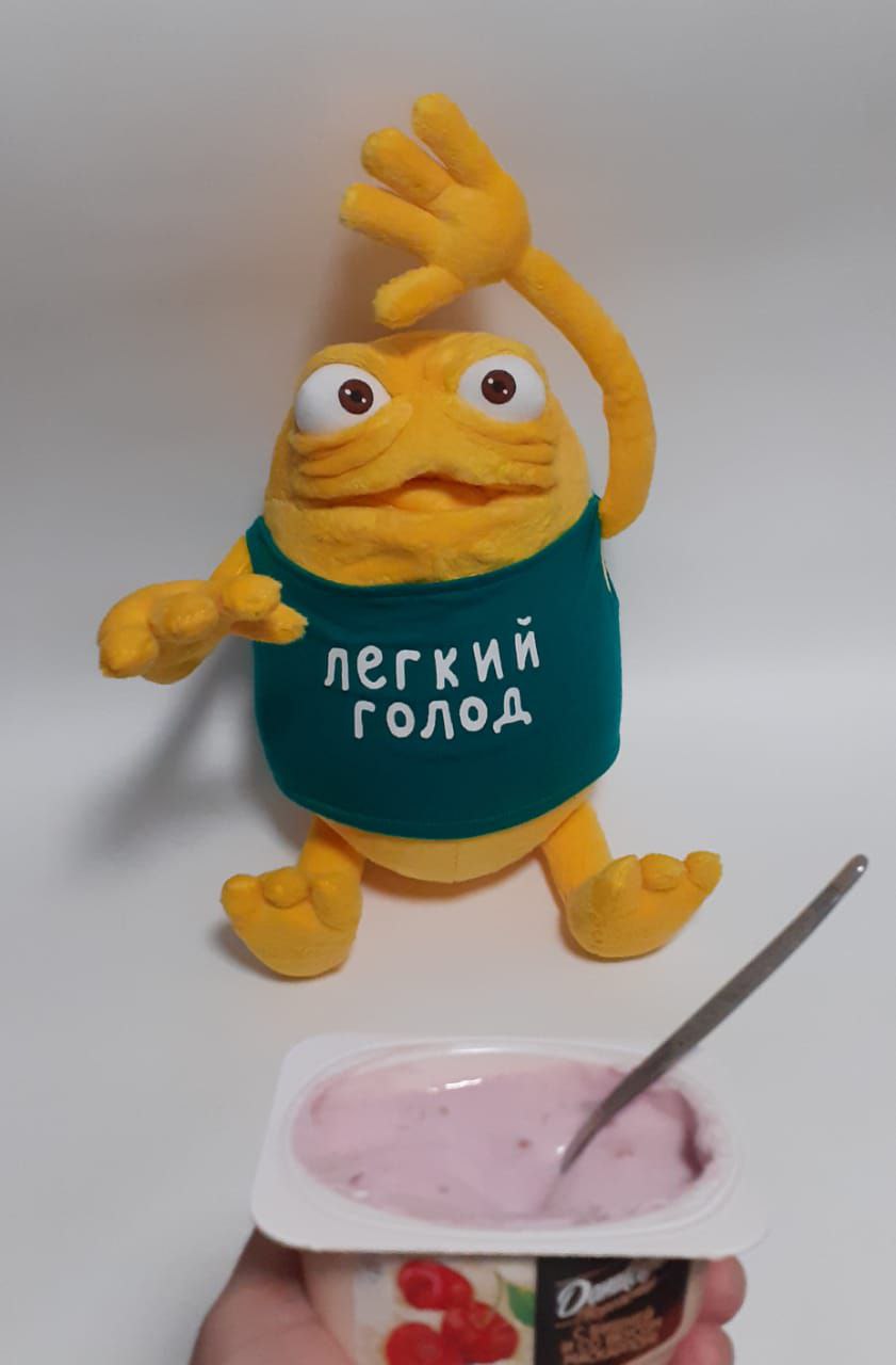Commercial mascot plush with a yogurt cup Yellow TV ad monster plush with one arm raised over a yogurt cup, a custom mascot plush sewn by hand