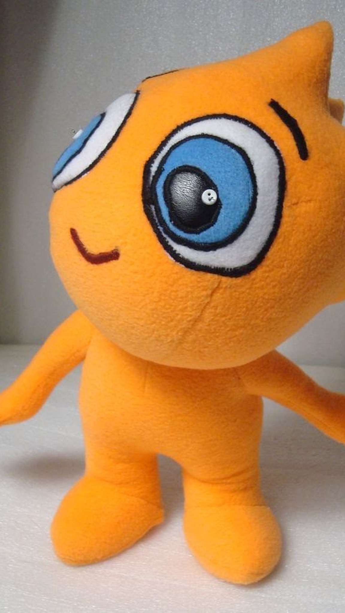 Company mascot plush from a cartoon: orange custom plush with big blue eyes and open arms, handmade to order