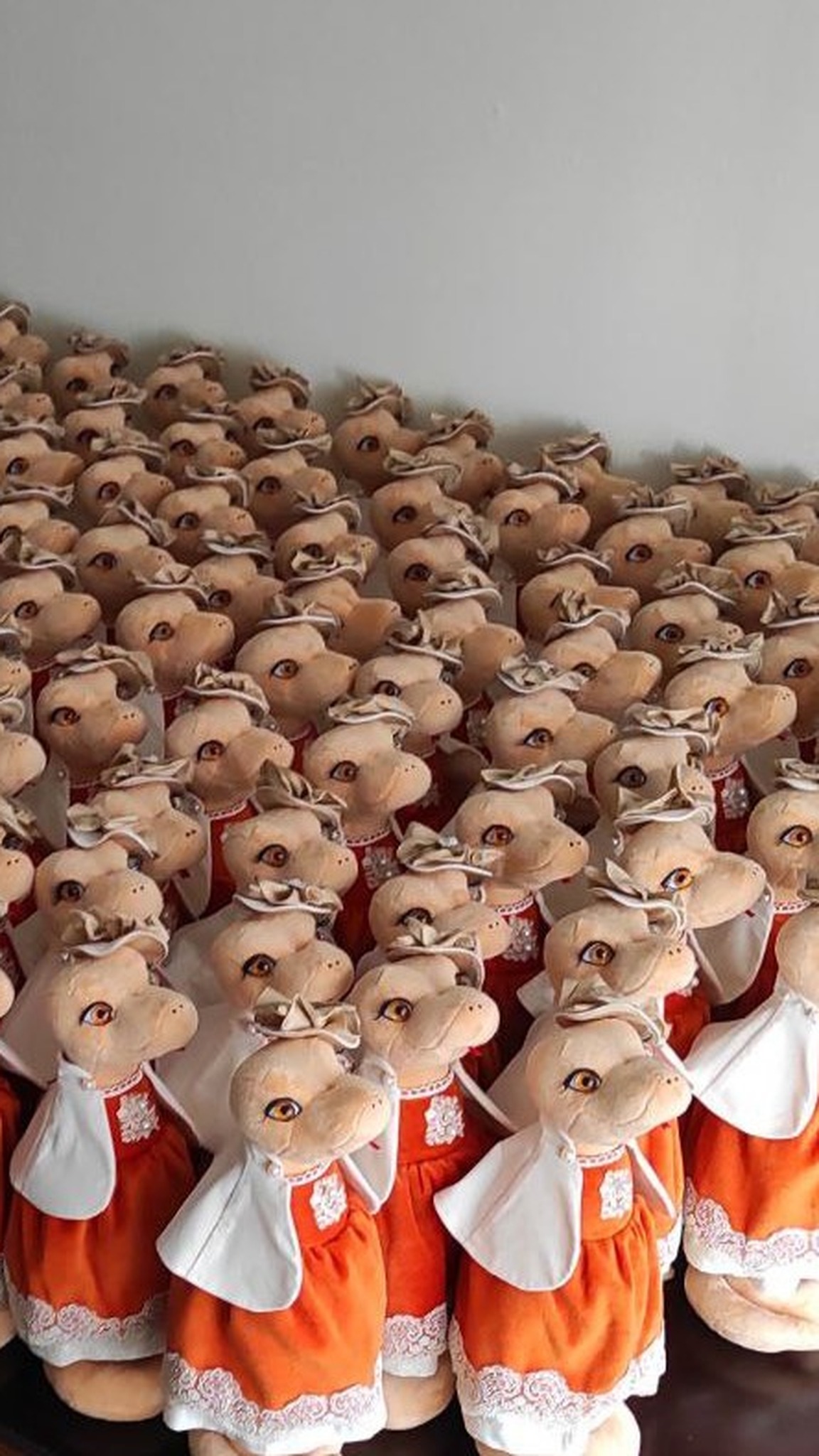 Batch of snake plush ladies in orange dresses, corporate plush toys made to order
