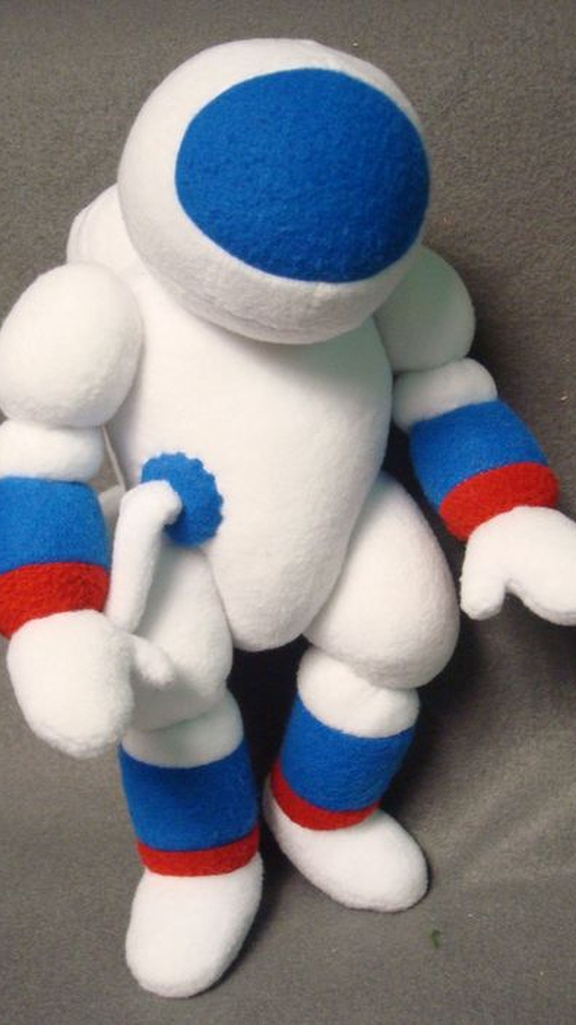 Custom cosmonaut plush in white fleece with mitten hands and blue cuffs, sewn to order for a TV show
