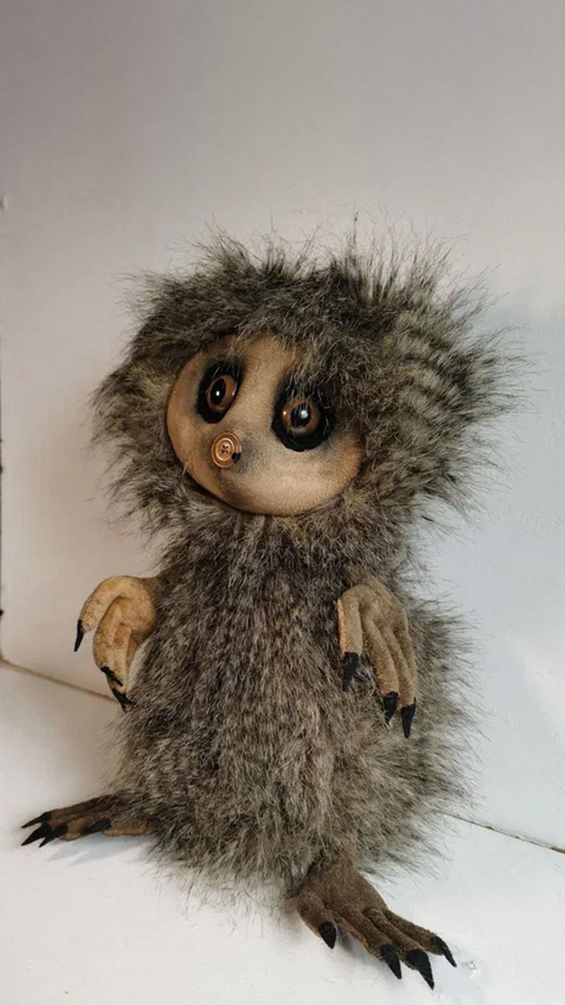 Creepy-cute creature plush with shaggy faux fur, long tan fingers and black claws, sewn to order from a drawing