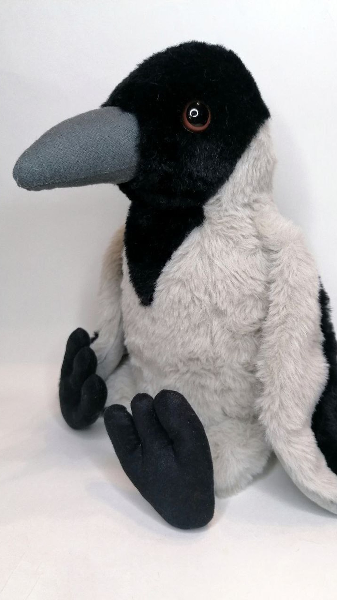Crow stuffed animal with a black hood, brown eyes and velvety three-toed feet, sewn by hand to order
