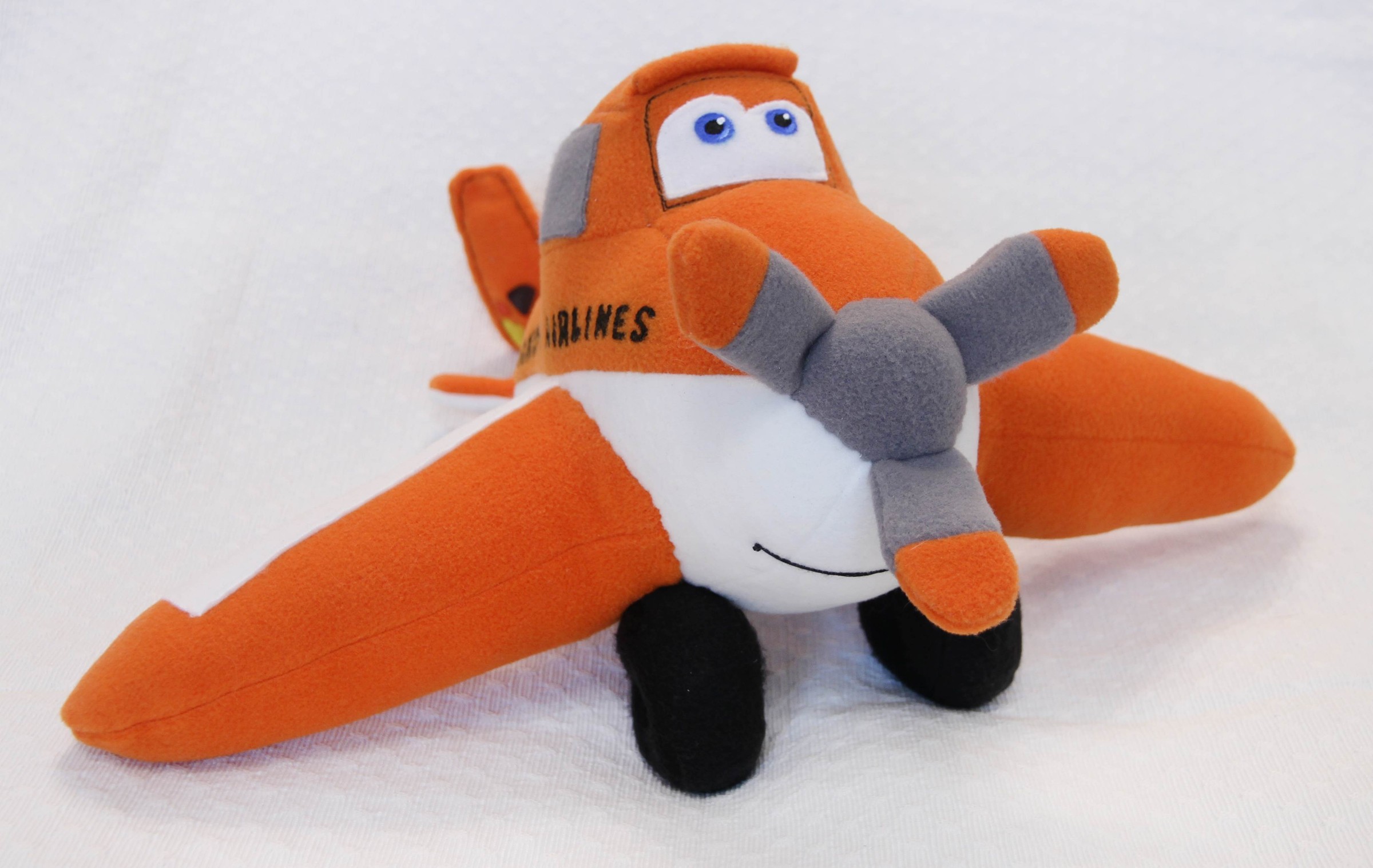 Custom airplane plush with an airline name Custom airplane plush of Dusty from Planes with an airline name on the side, sewn to order as a joke gift